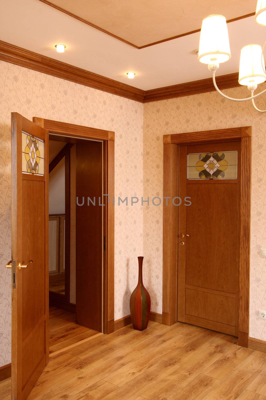 Room without furniture with a parquet floor and two wooden doors