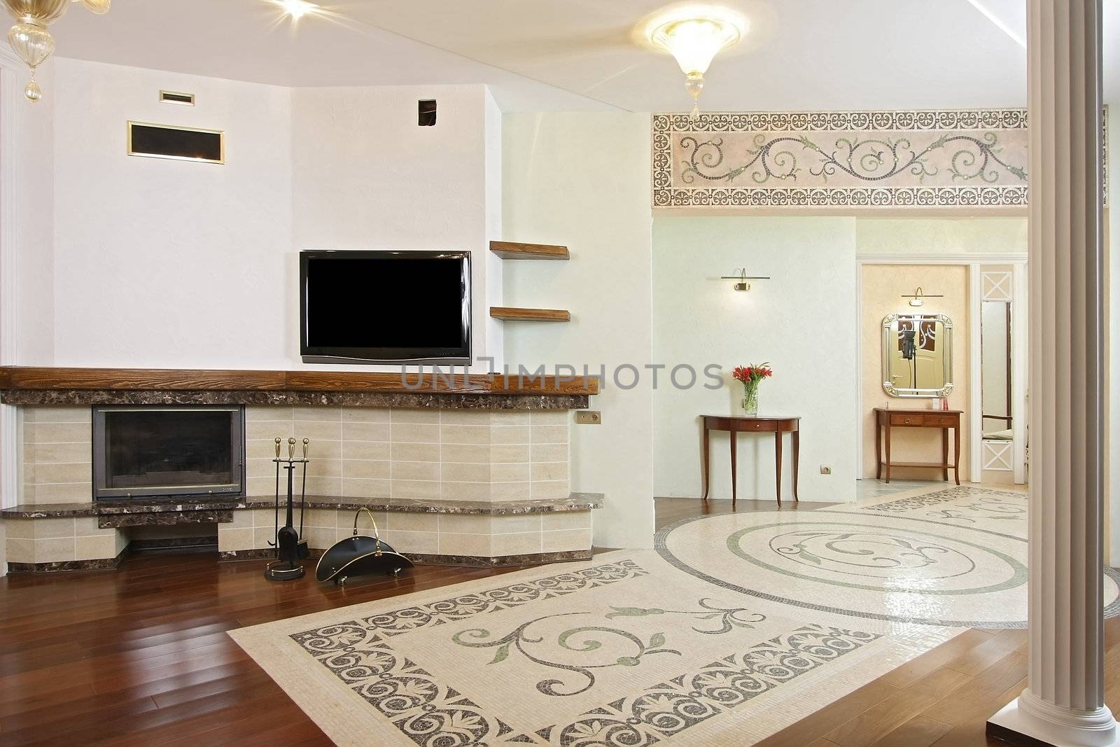 
Spacious hall with a fireplace, the TV and a beautiful mosaic ornament on a floor and a wall