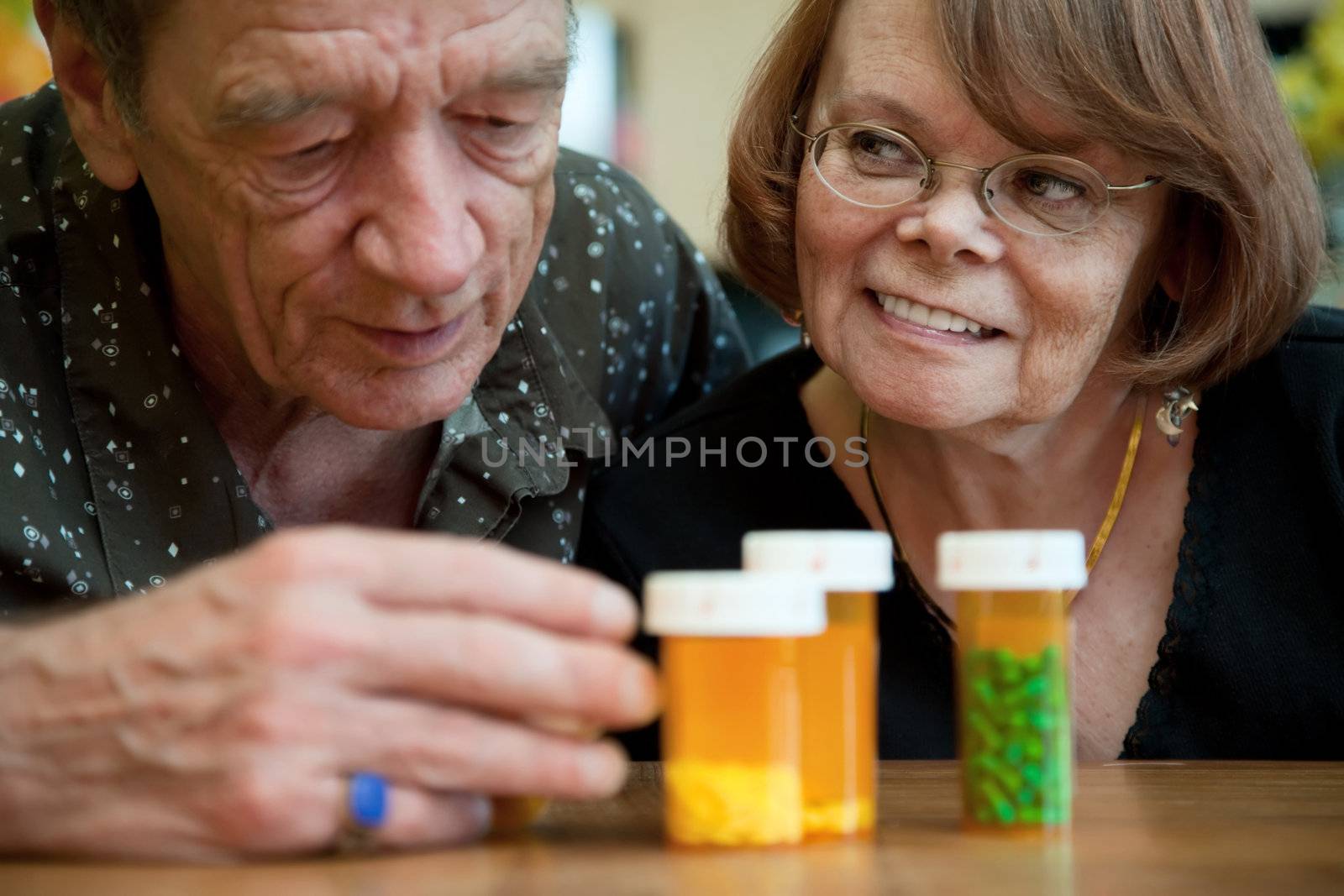 Senior couple closely examining instructions on prescription medications