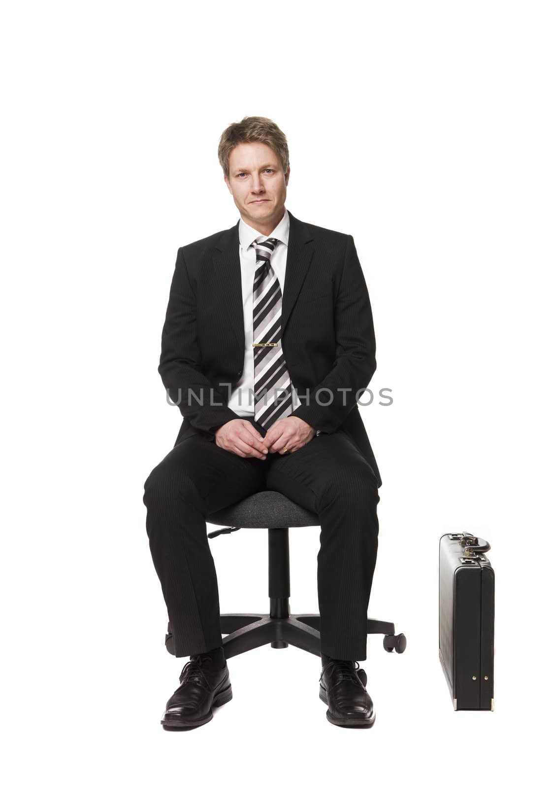 Buisnessman siting on a office chair by gemenacom
