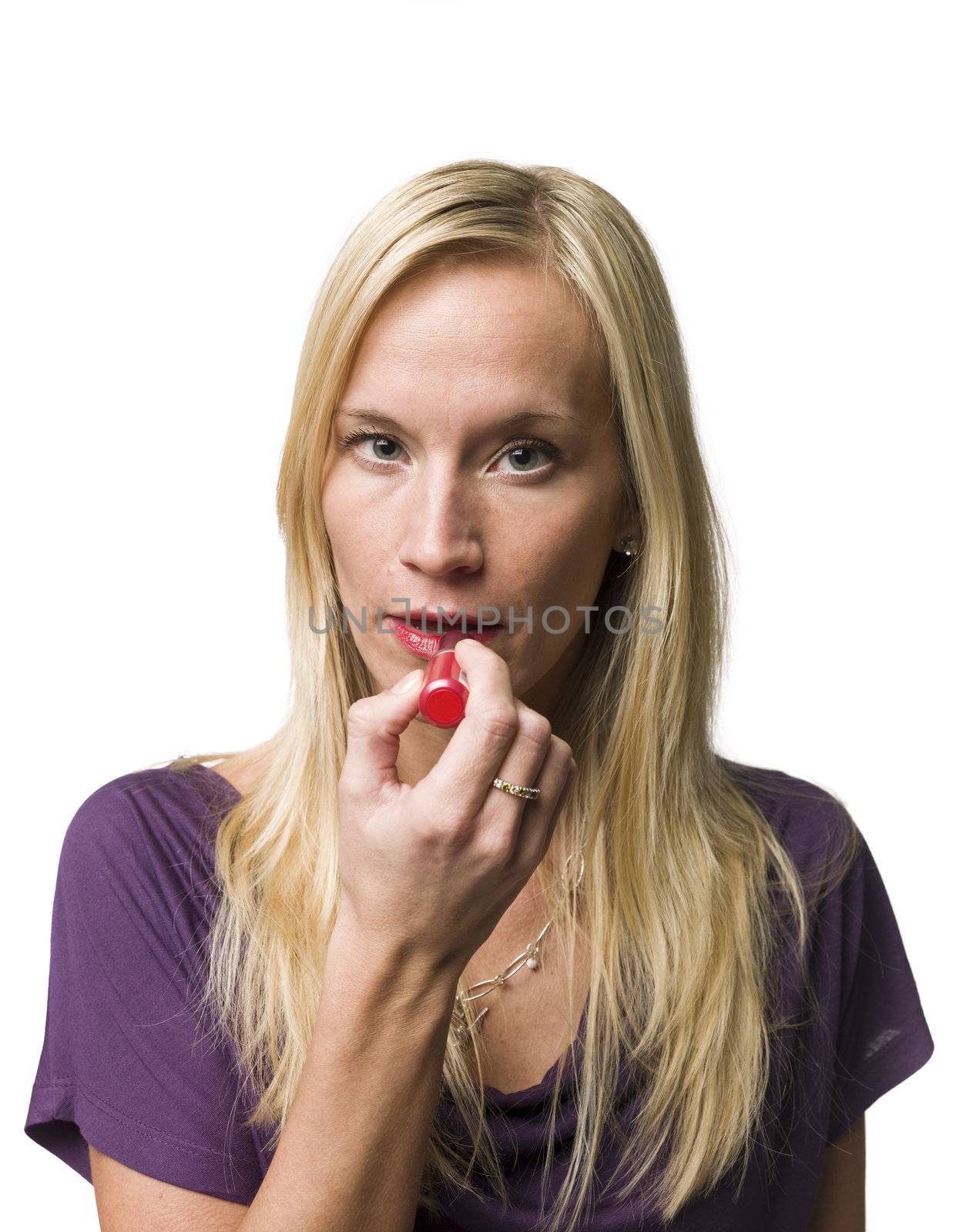 Woman puting lipstick on