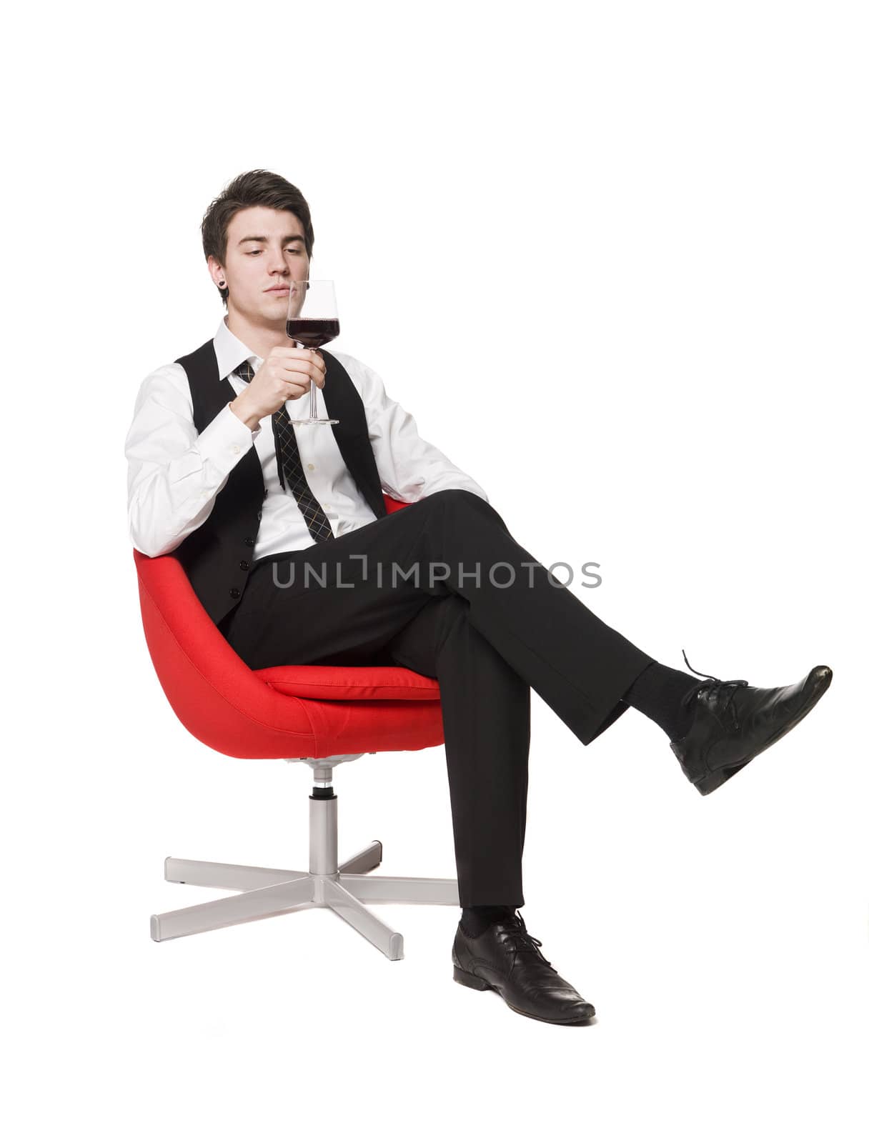 Man in a armchair drinking wine