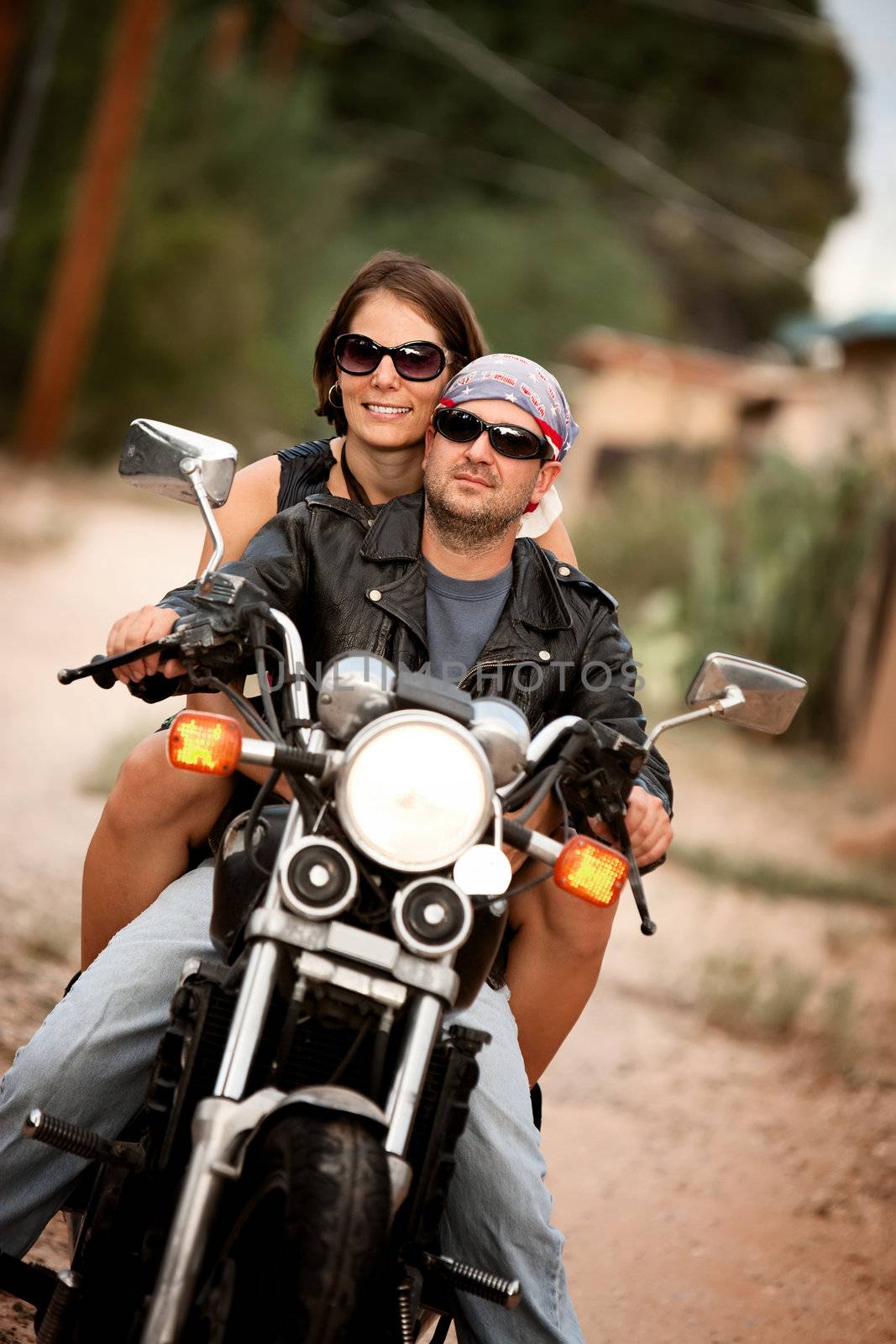 Man and Woman riding on vintage motorcyle 