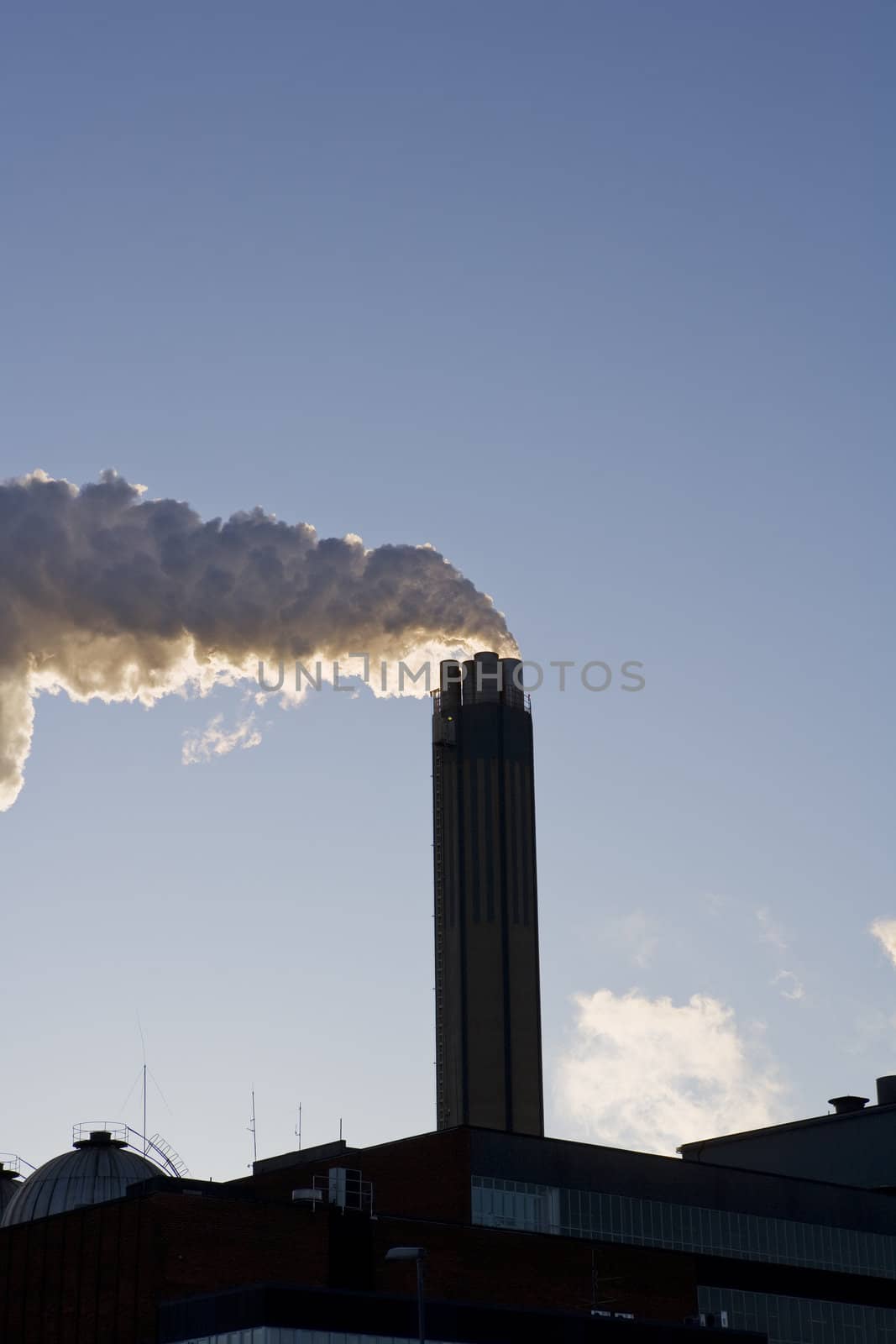 Smoking chimney against a blue sky
