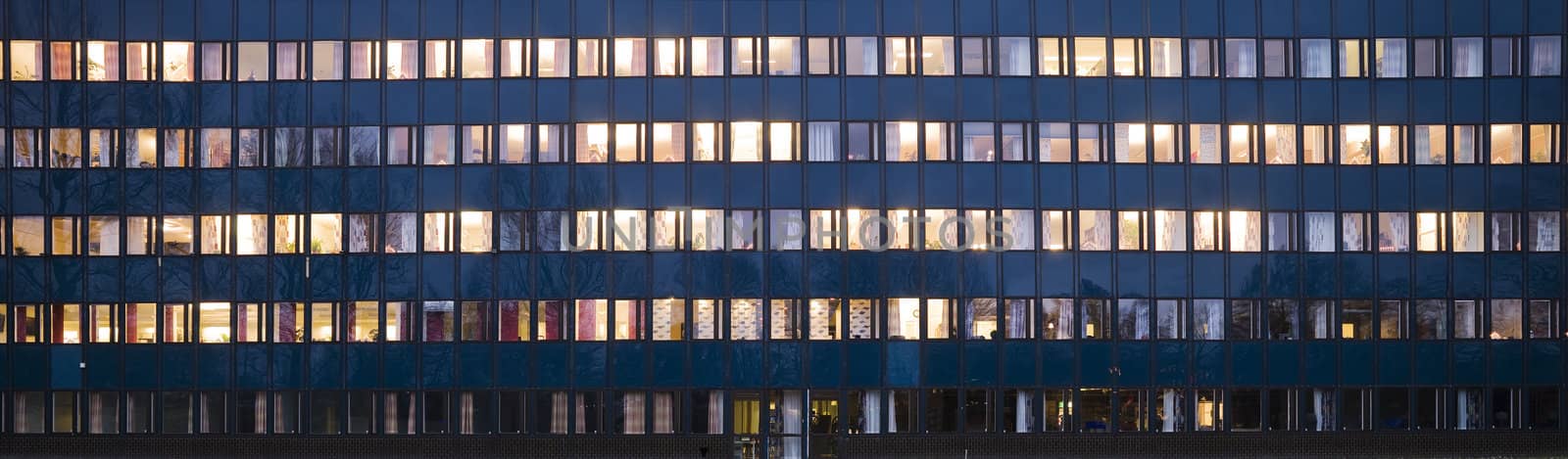 Windows glowing in the night on an office building