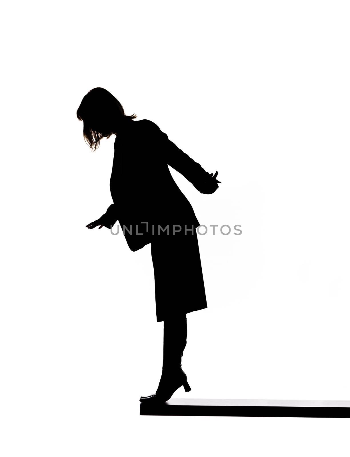 Silhouette of a woman close to fall down by gemenacom