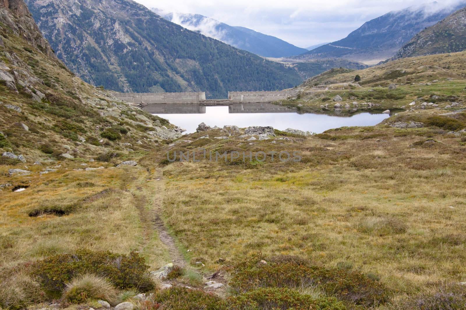 Dam on the mountain lake in Pyrenees - Andora.