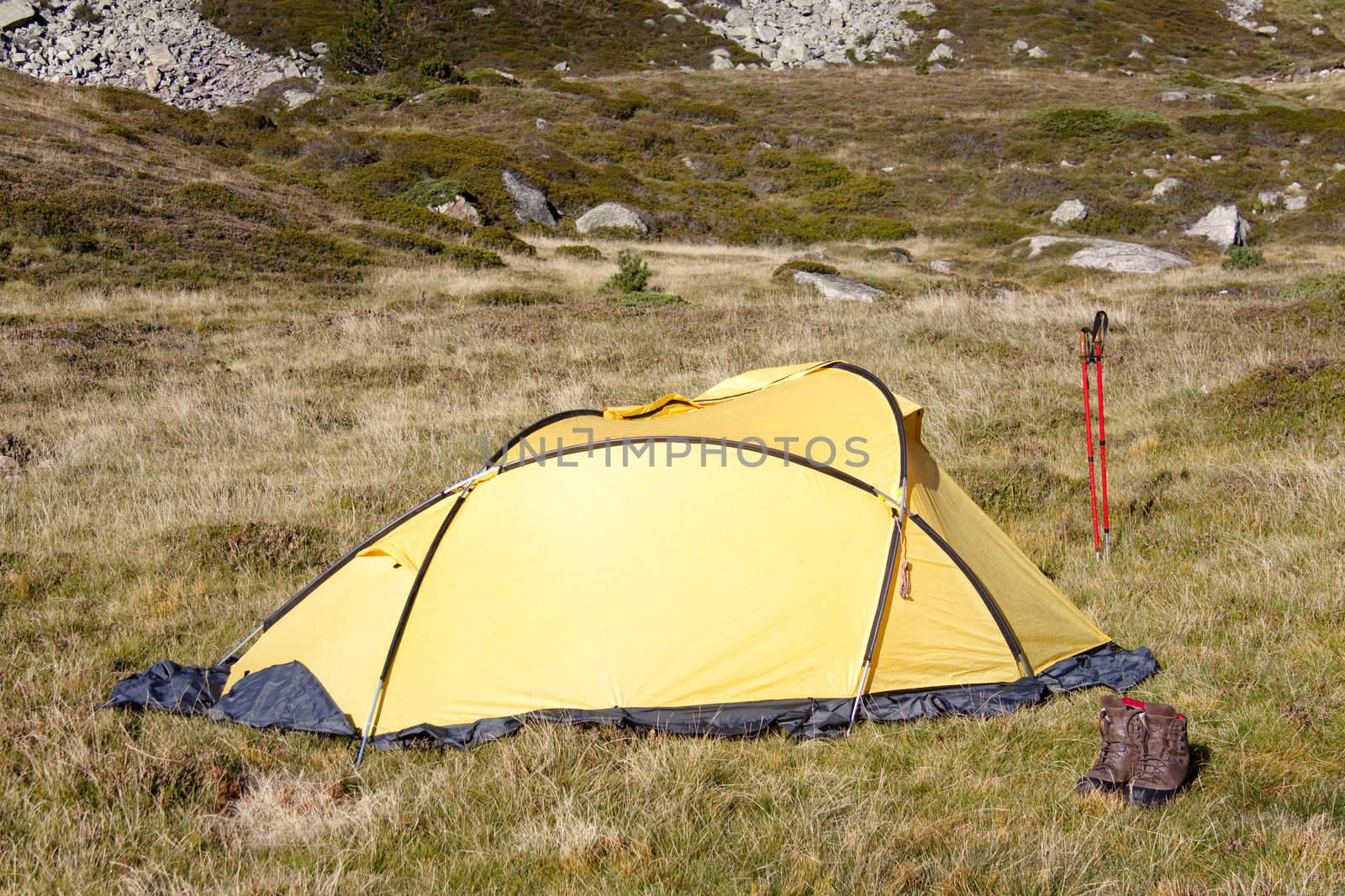 Camp in Pyrenees mountain in Andora. Small yellow tent
