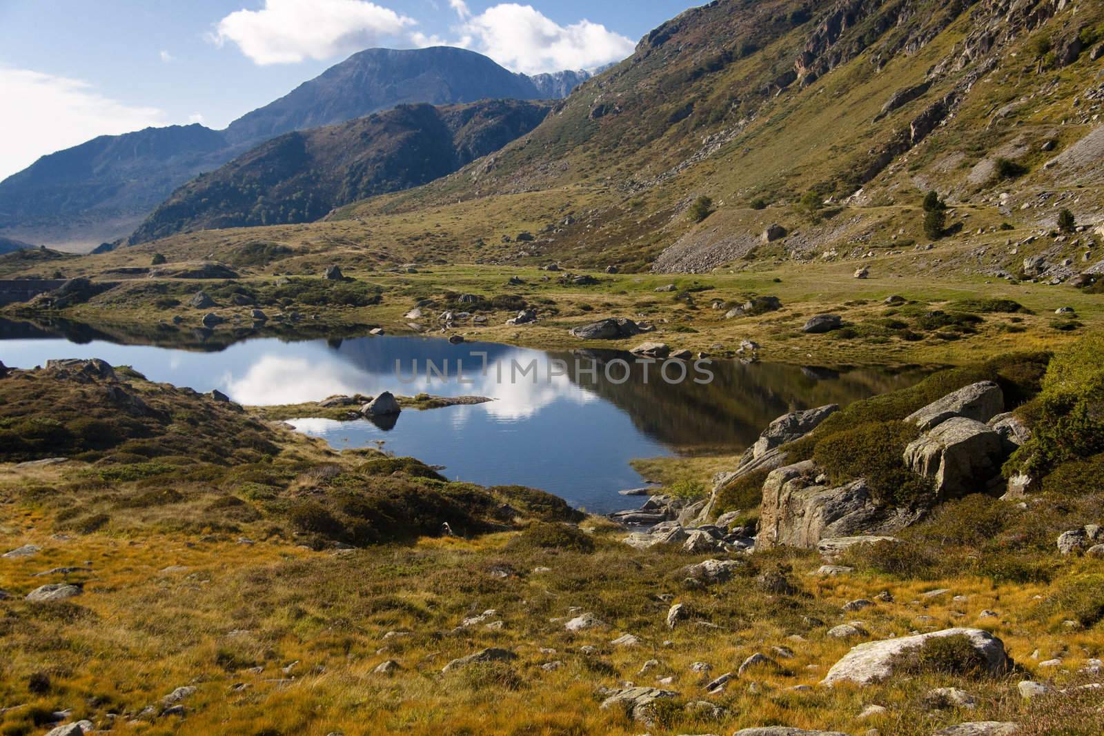 Summer day, blue sky in Andora - Pyrenees. Small pond