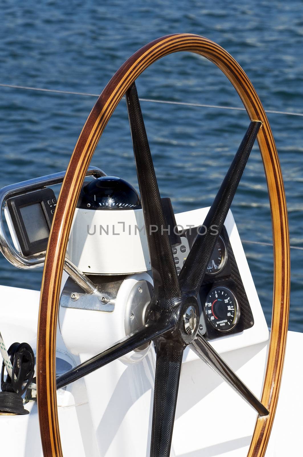 Detail of rudder, compass and nautical instruments of a sailing boat