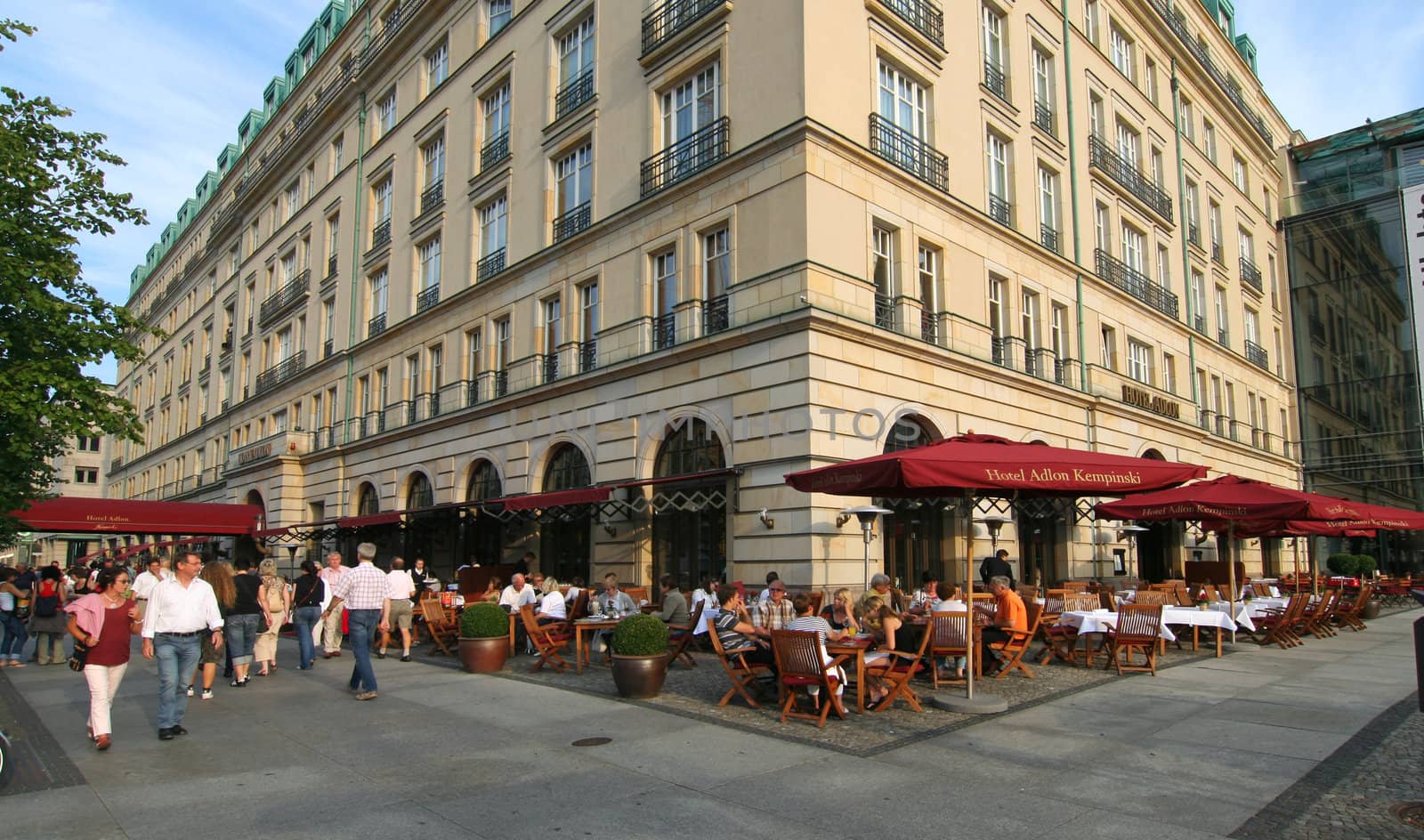 People in outside cafe of Hotel Adlon on Unter den Linden main street of Berlin, Germany