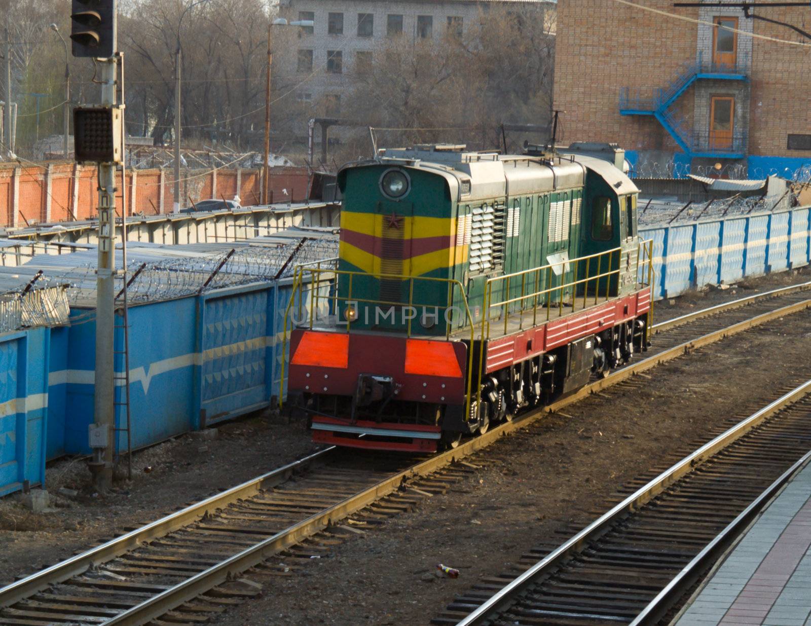 The old diesel locomotive of green colour moves on rails