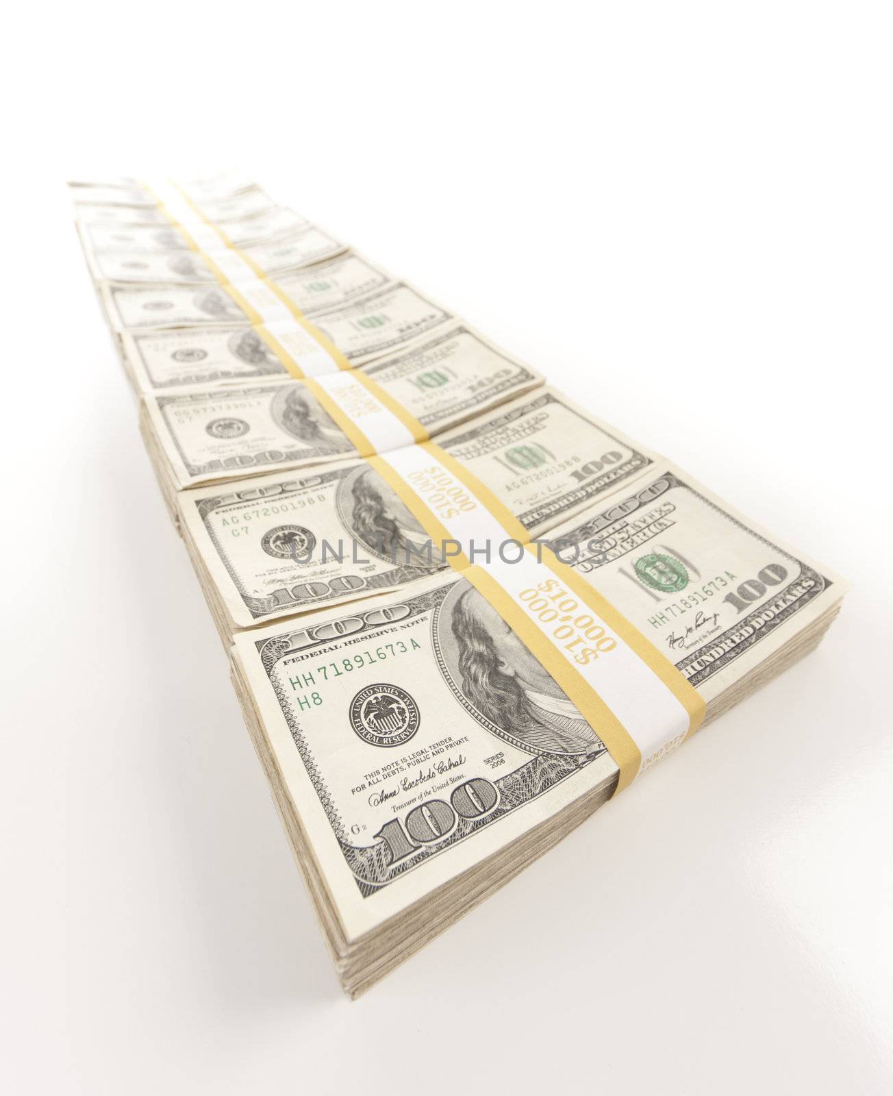 Fading Row of Stacks of Hundred Dollar Bills Isolated on a White Background.