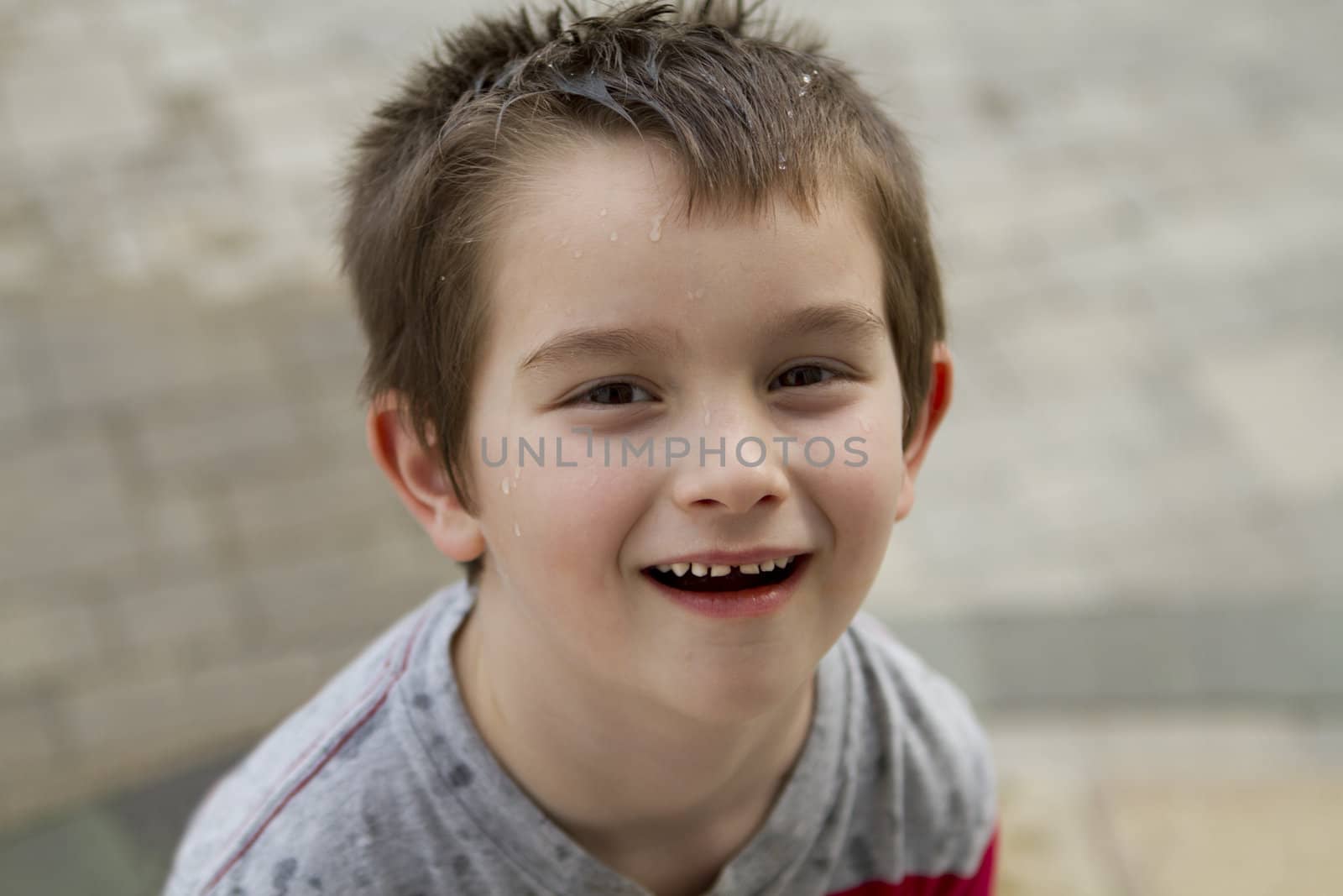 Six years old kid looking at camera, shot from above