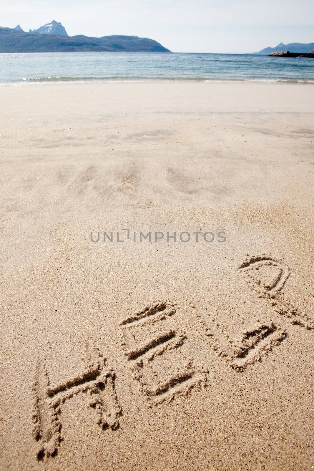 Help written in the sand on a deserted island