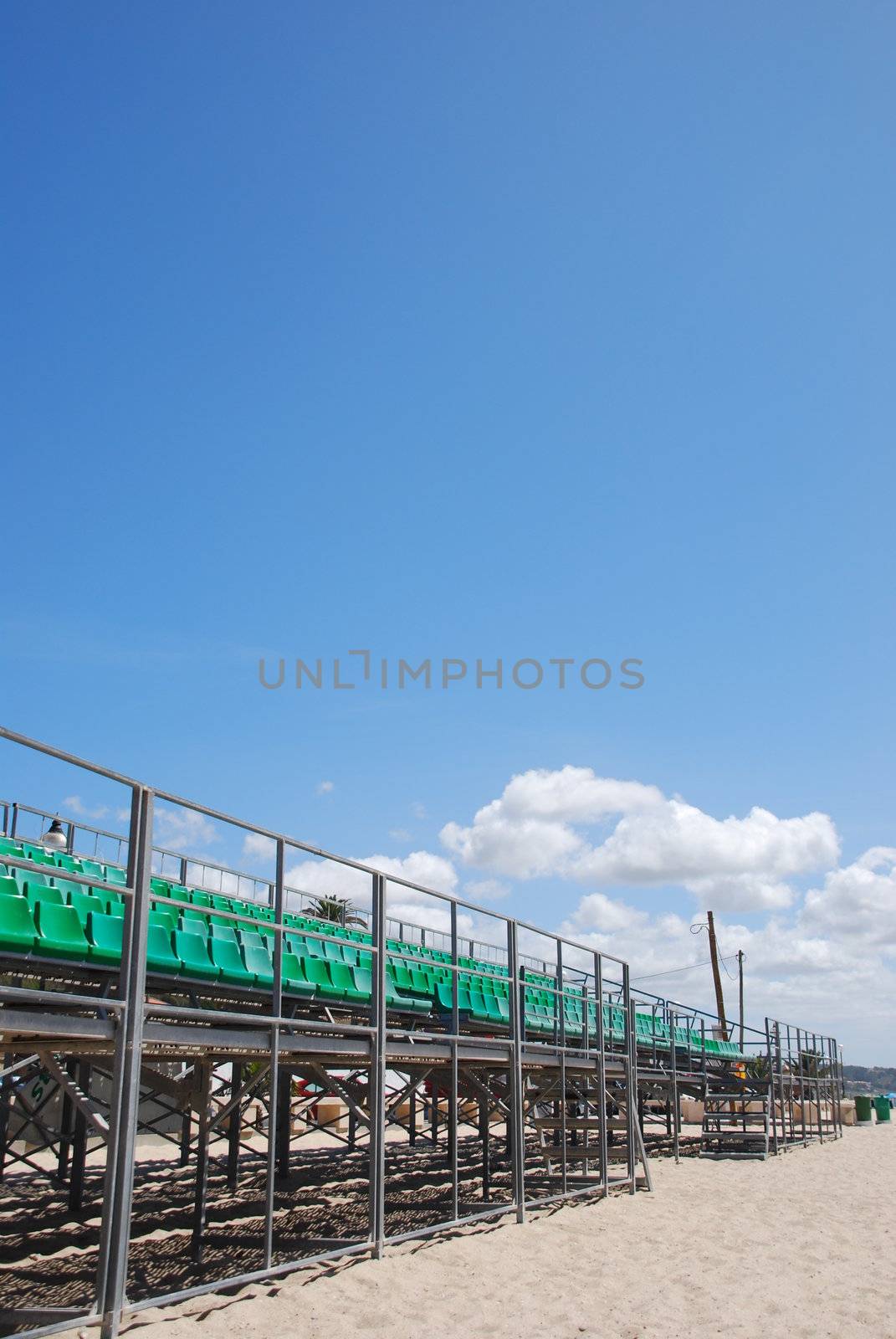 photo of green stadium bleachers on the beach