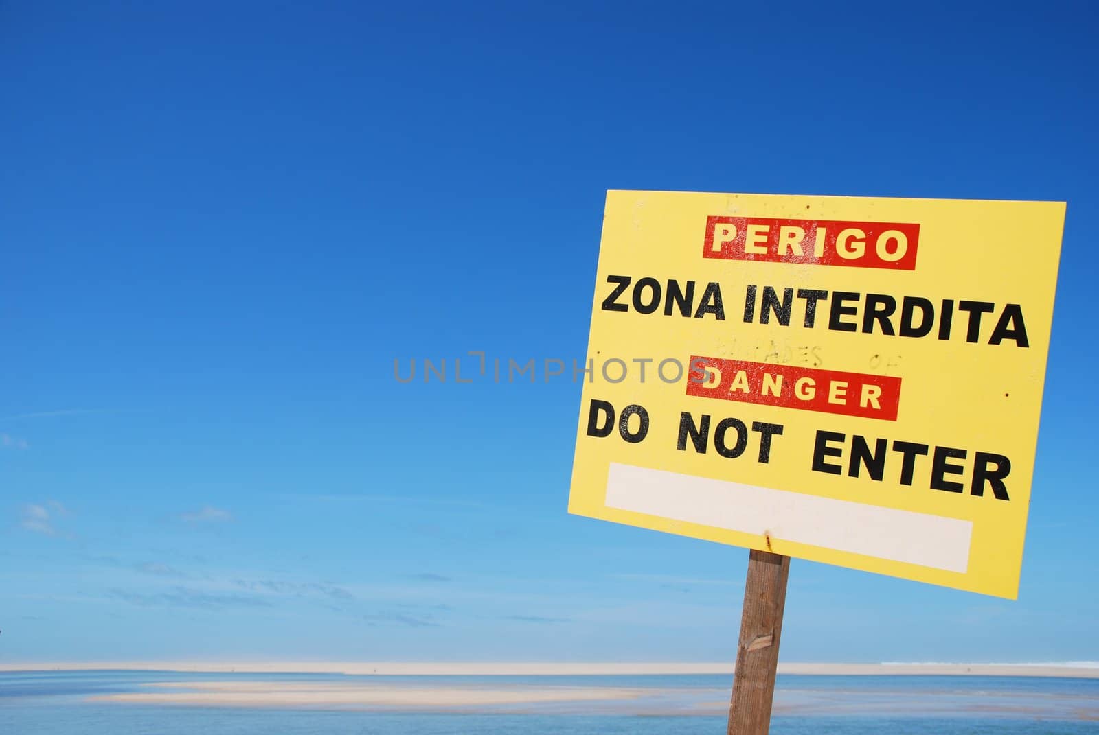 yellow do not enter sign on a dangerous zone at the beach