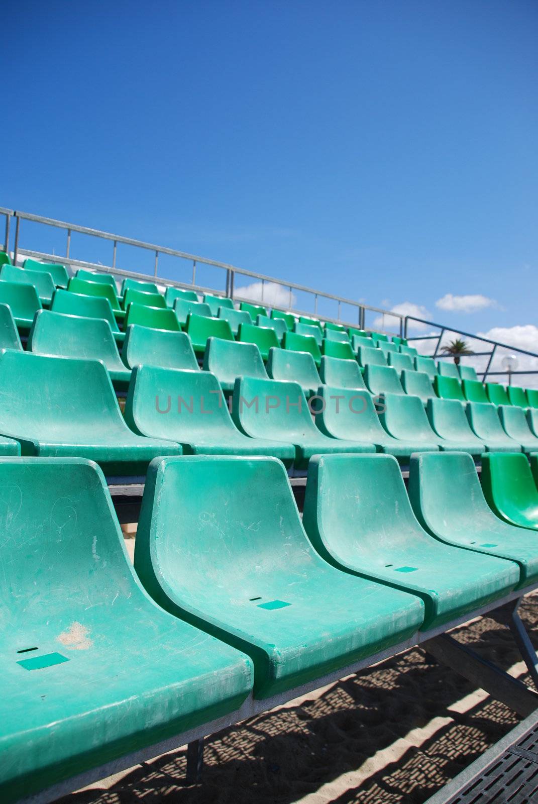 photo of green stadium bleachers on the beach