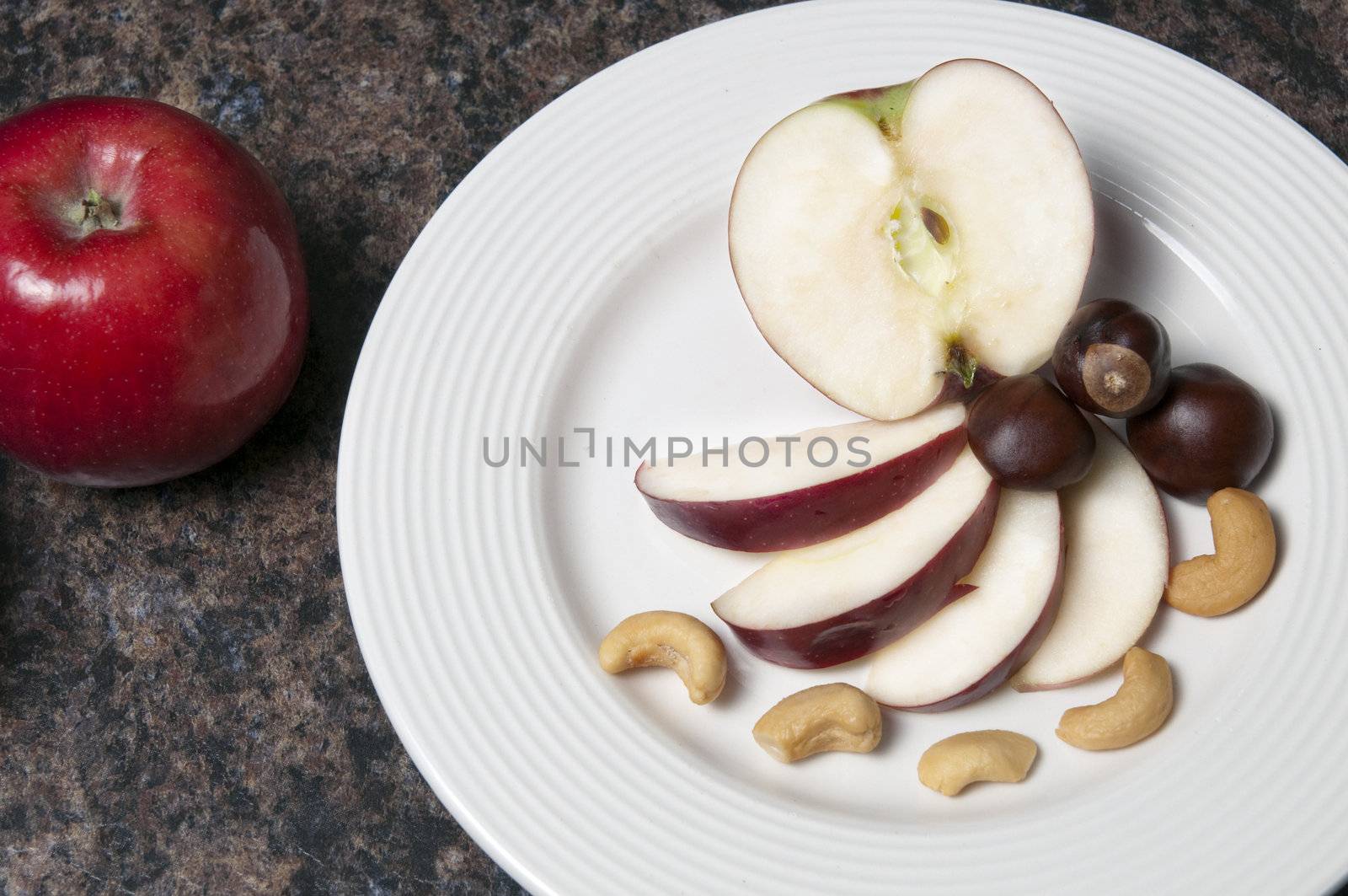 Arrangement of apples and nuts on a white plate
