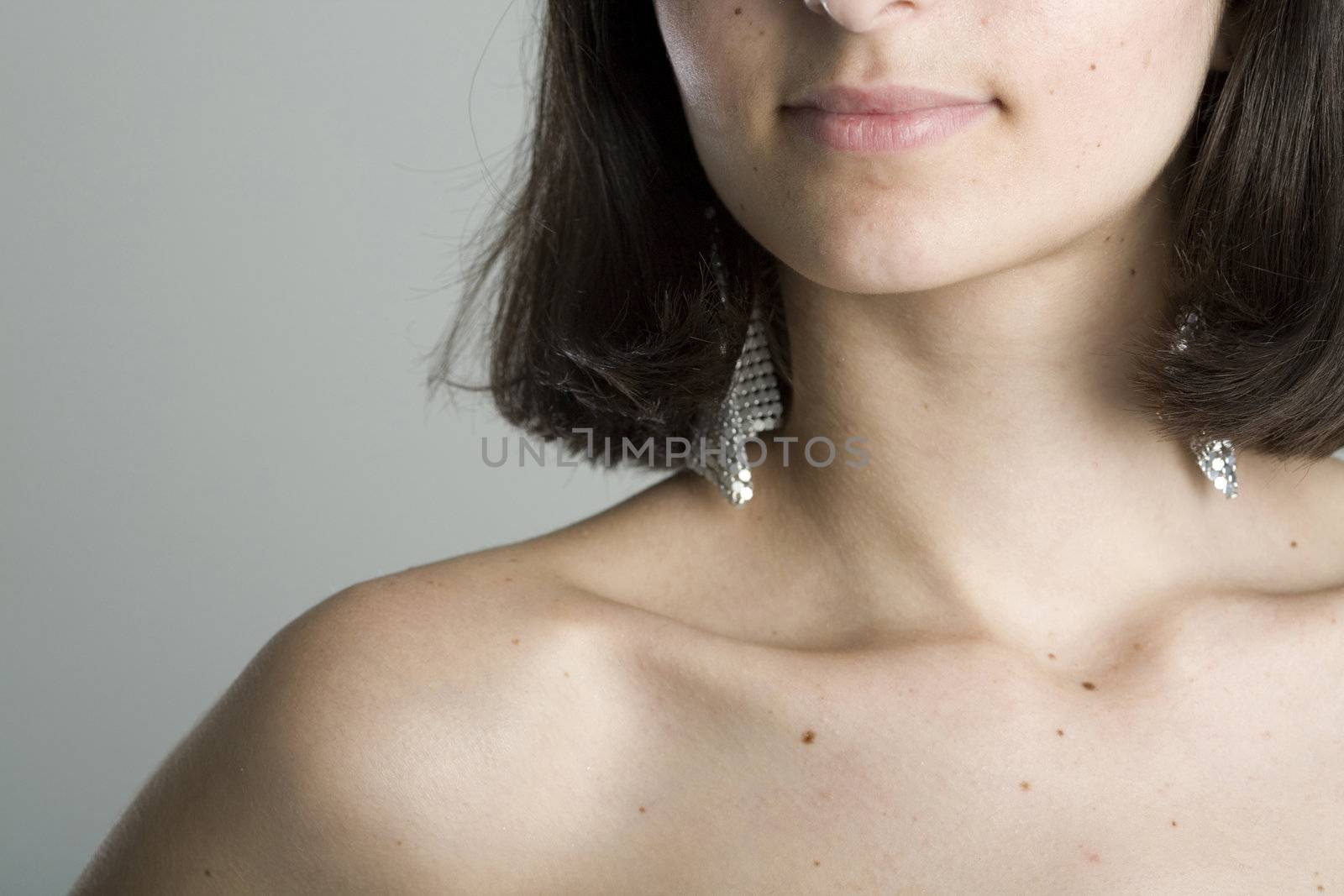 An 18 year old exotic brazilian model, with short dark hair, a young looking face and a skinny body. This was shot in a studio and she's weariing a black, strapless dress.