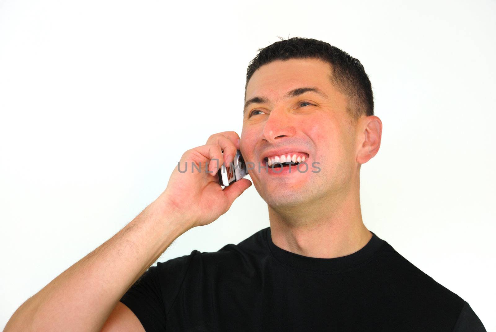 A portrait of a smiling Caucasian man talking on a mobile phone isolated over white background.