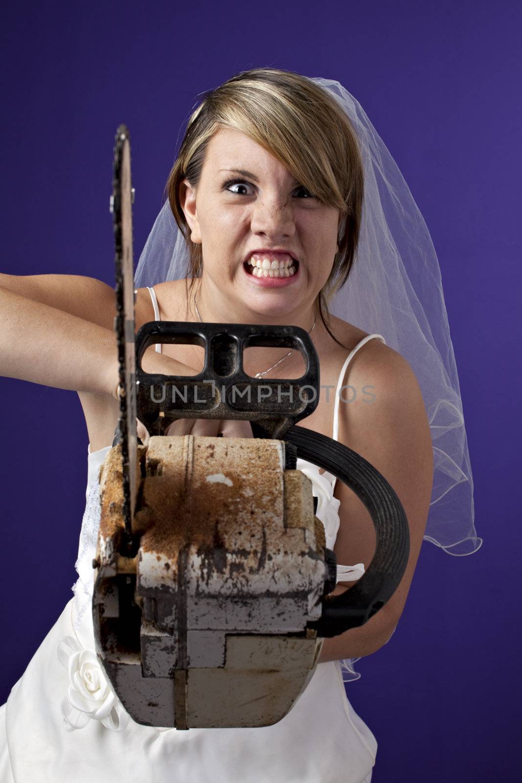 angry young bride with an chainsaw on a dark blue background