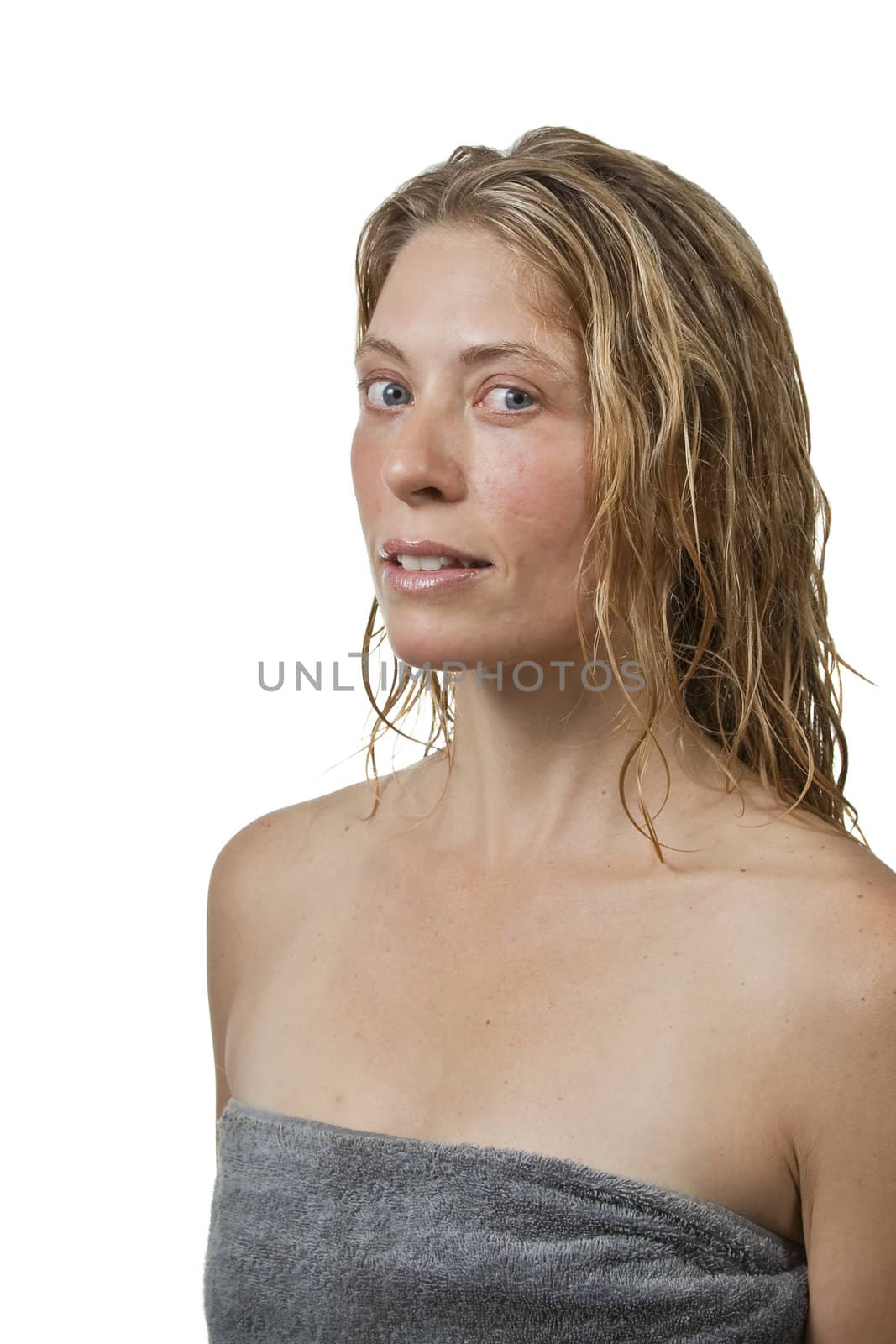 Blond woman out of bath in spa, relaxed, looks at camera