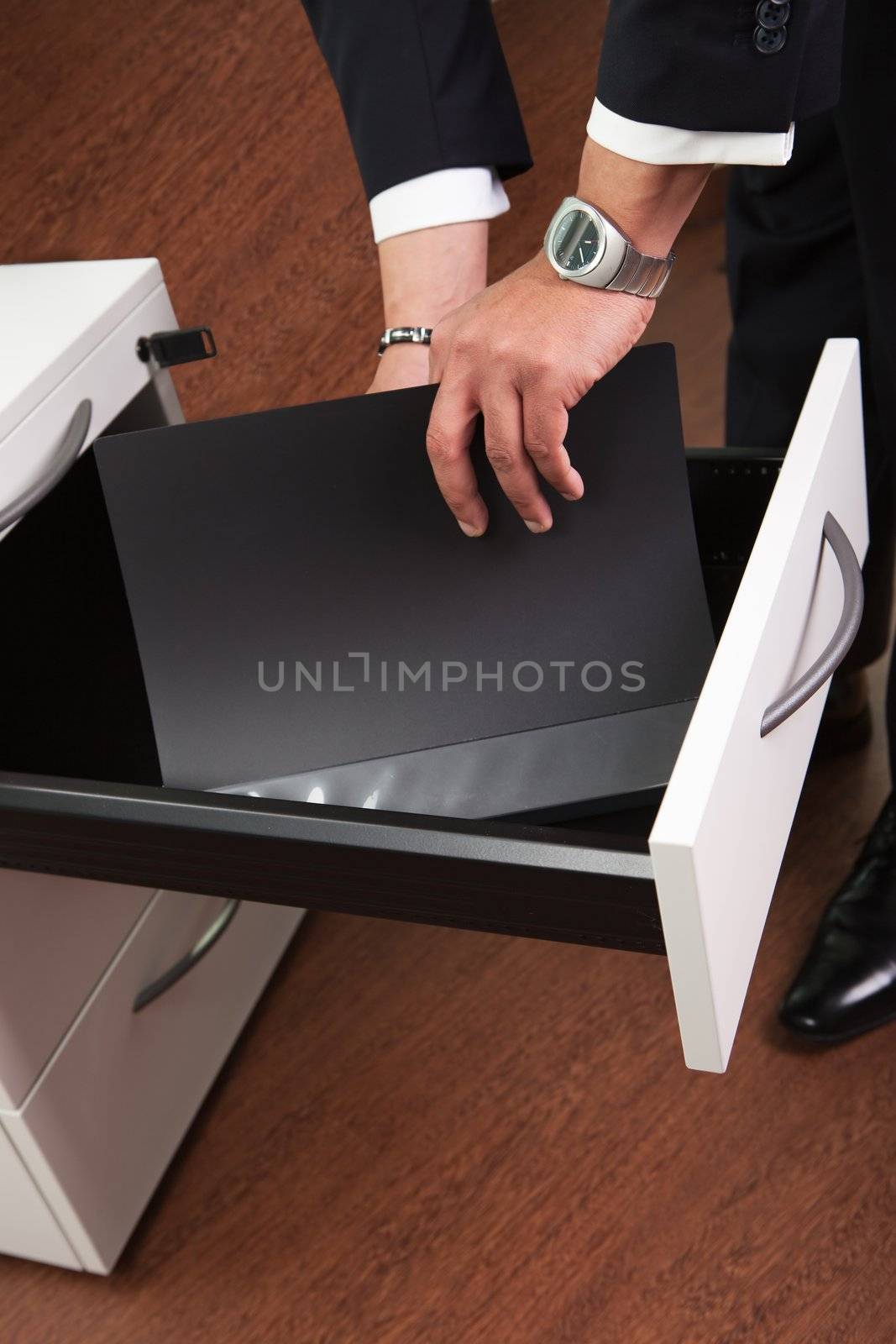 Businessman Taking Documents from the Drawer in the office