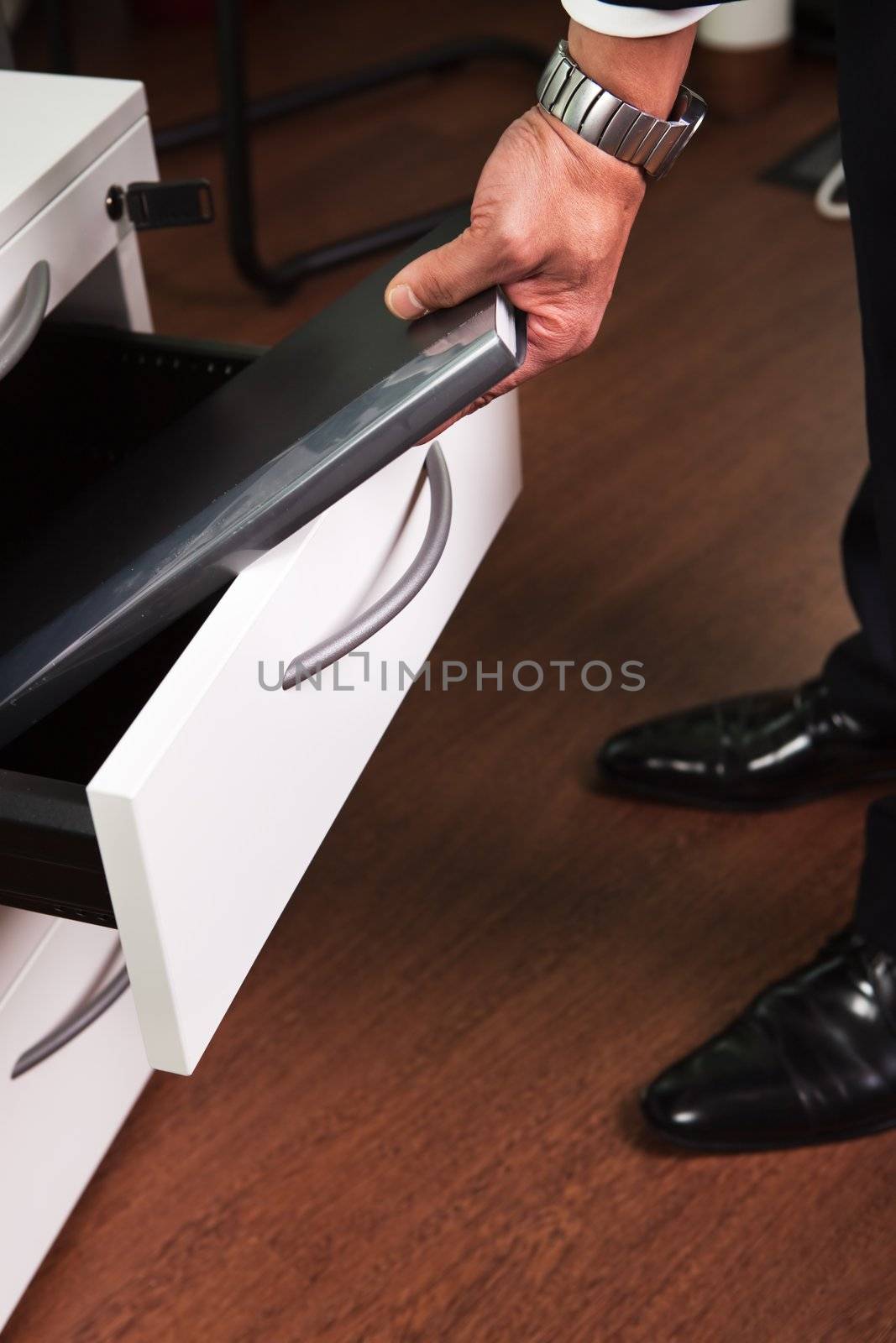 Businessman Taking Documents from the Drawer in the office