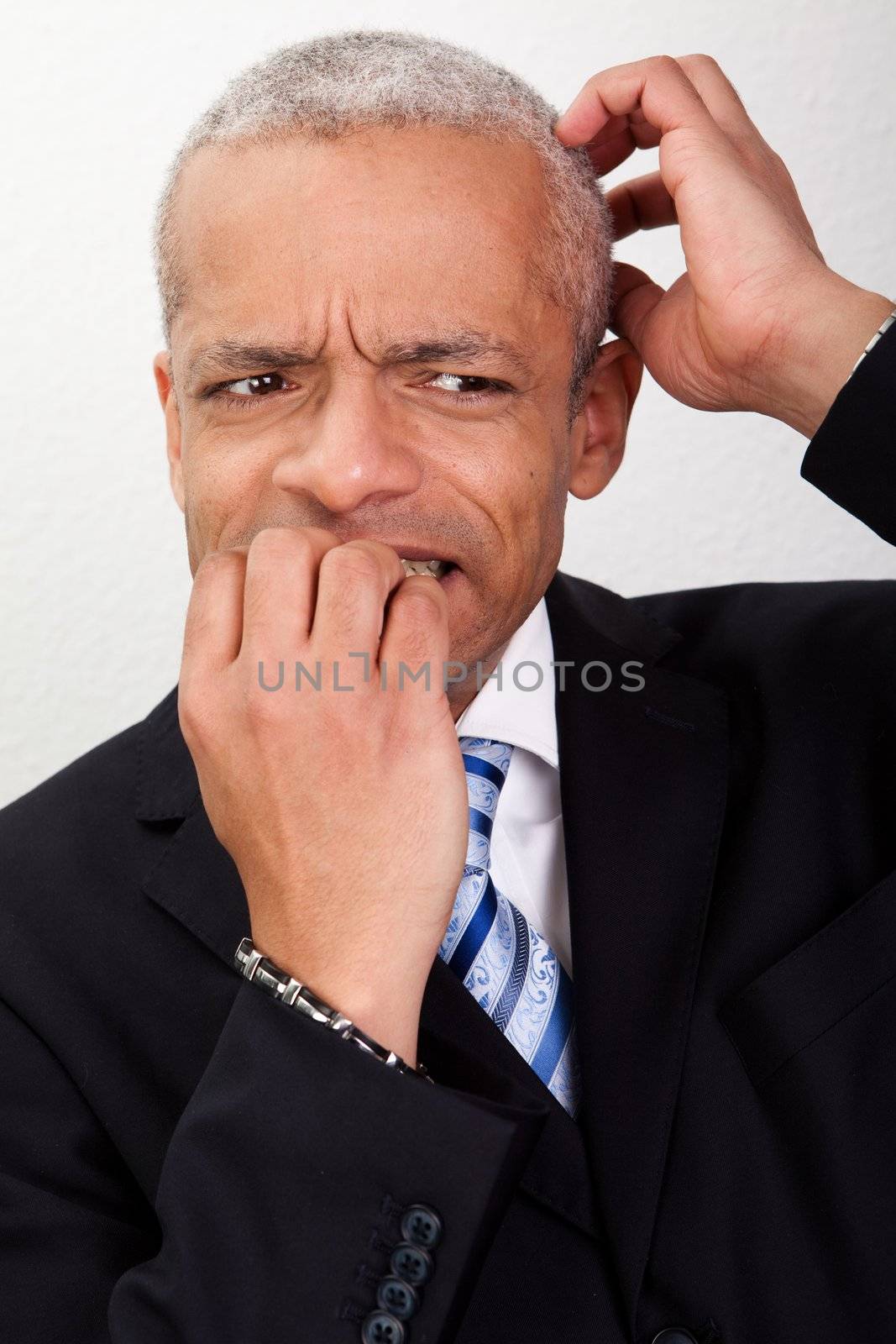 Stressed Businessman Biting His Nails And Scratching His Head