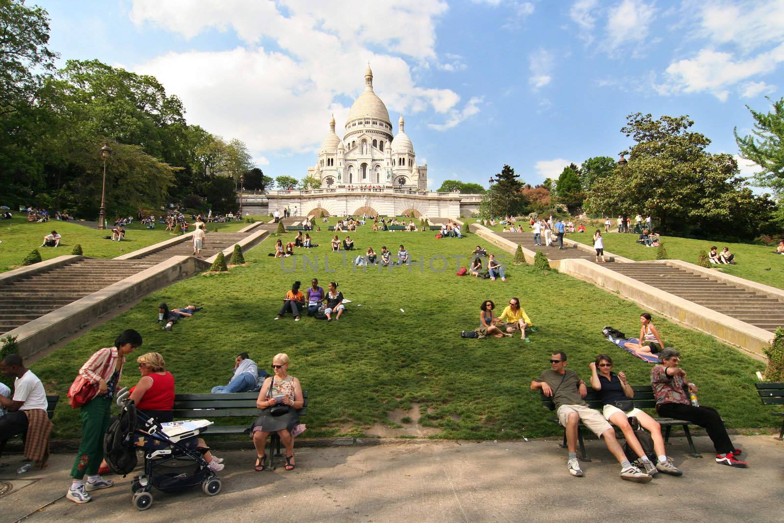 People sitting in the park beneath Sacre Coeur Church in Paris on April 25, 2007.