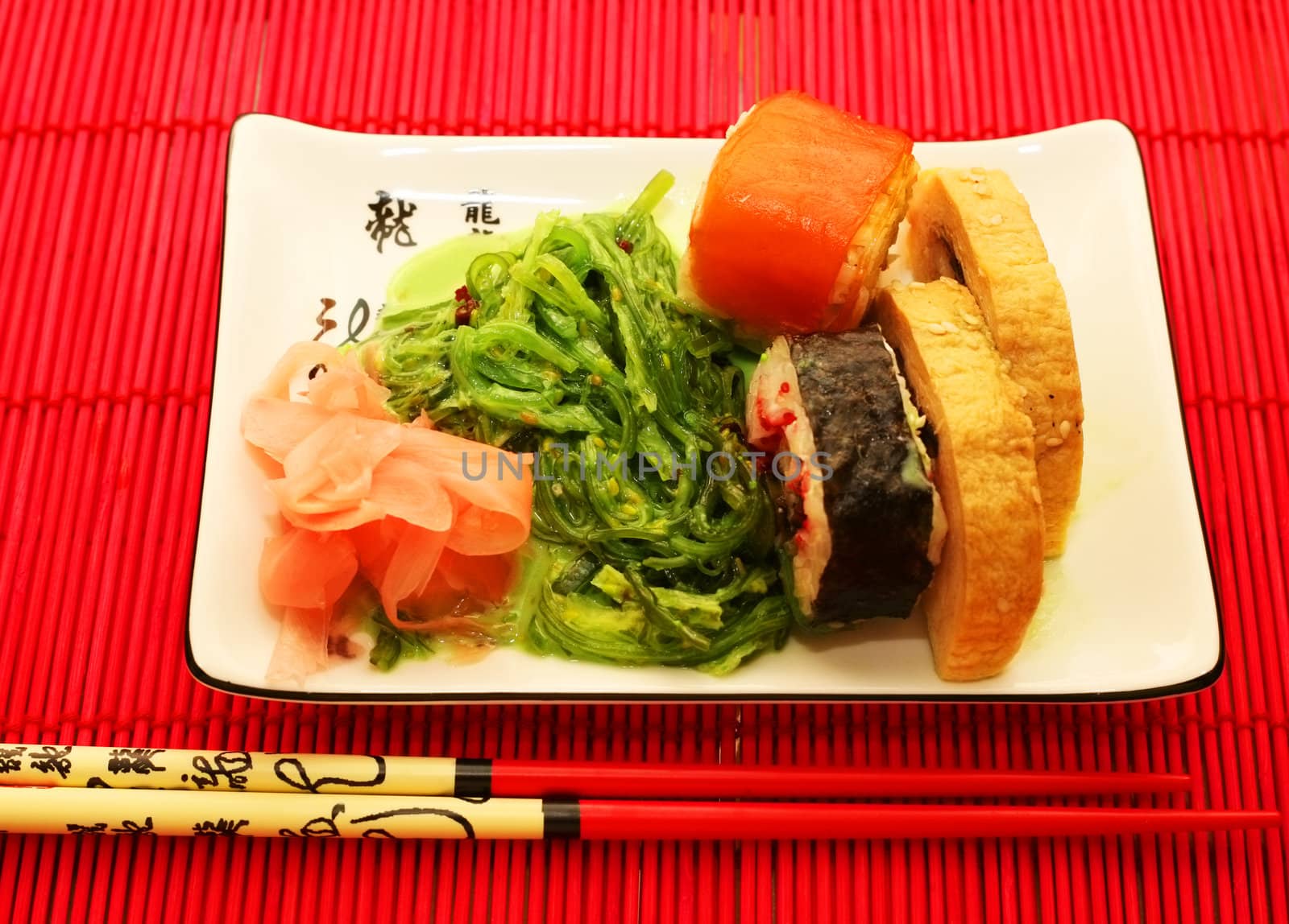 sushi and chopsticks close-up on red background