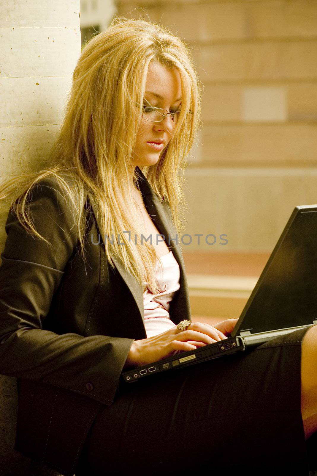 beautiful young business student typing on a laptop