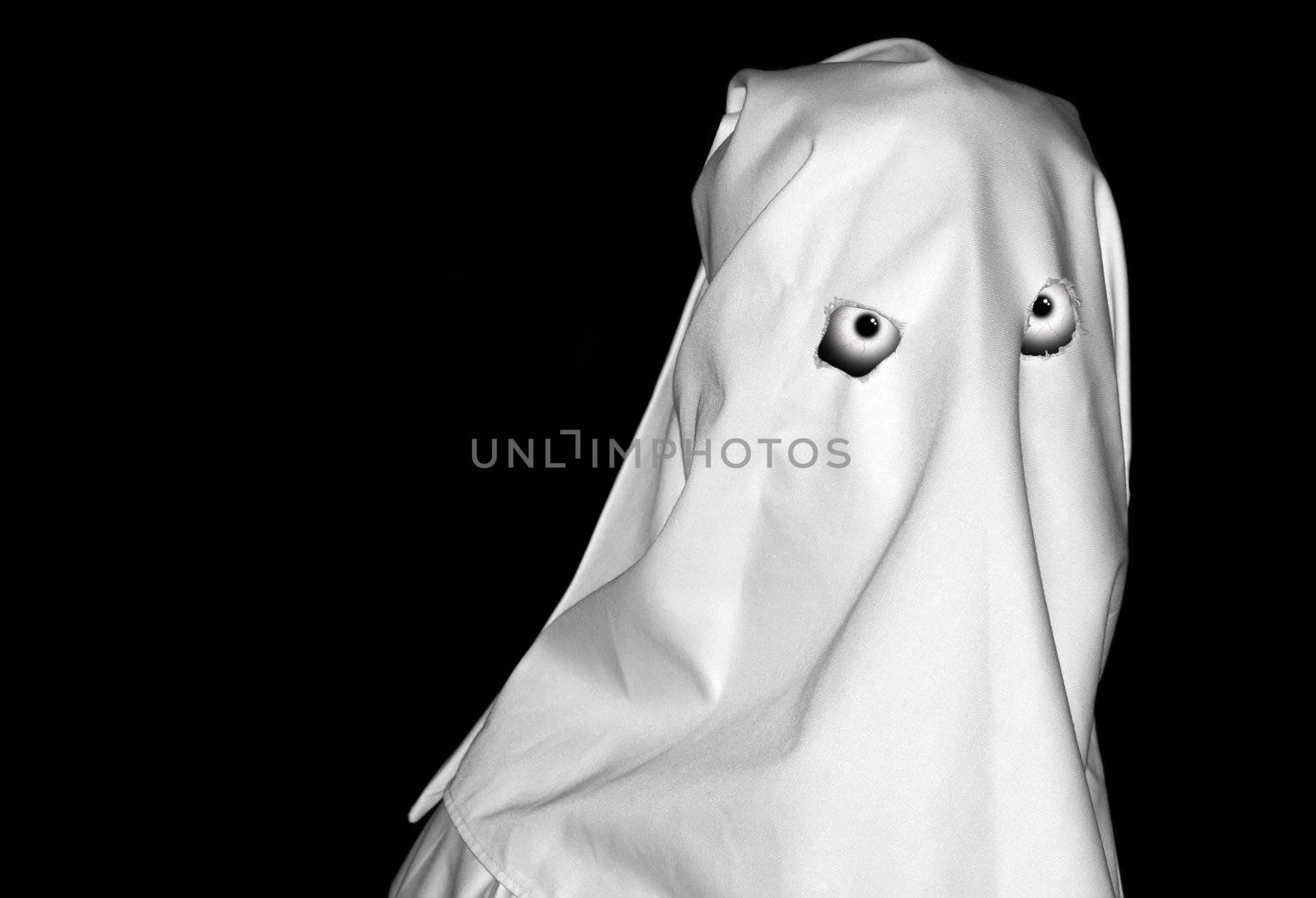 Spooky white figure over clear black backdrop