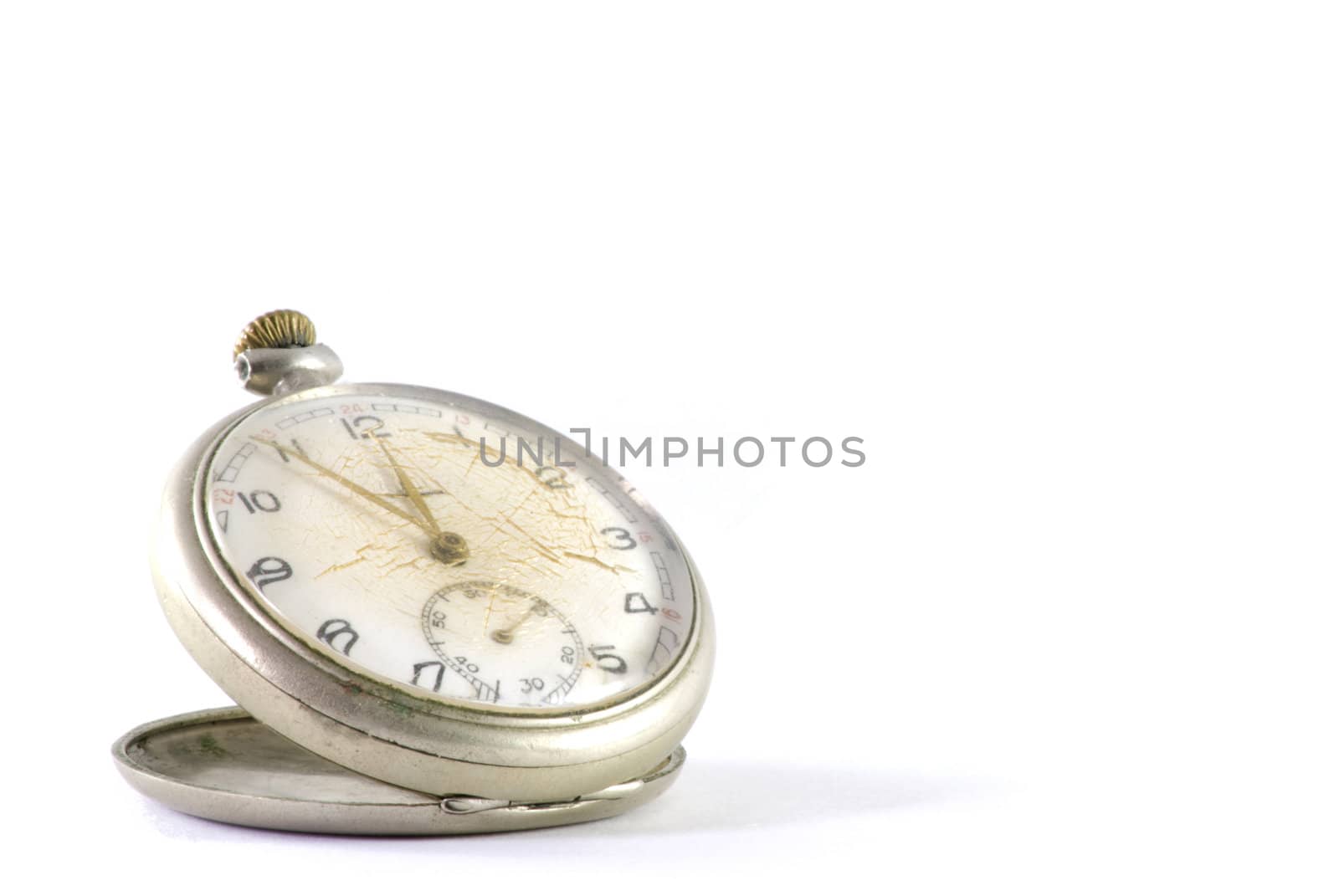 Old pocket clock with glass cracked. Isolated on white