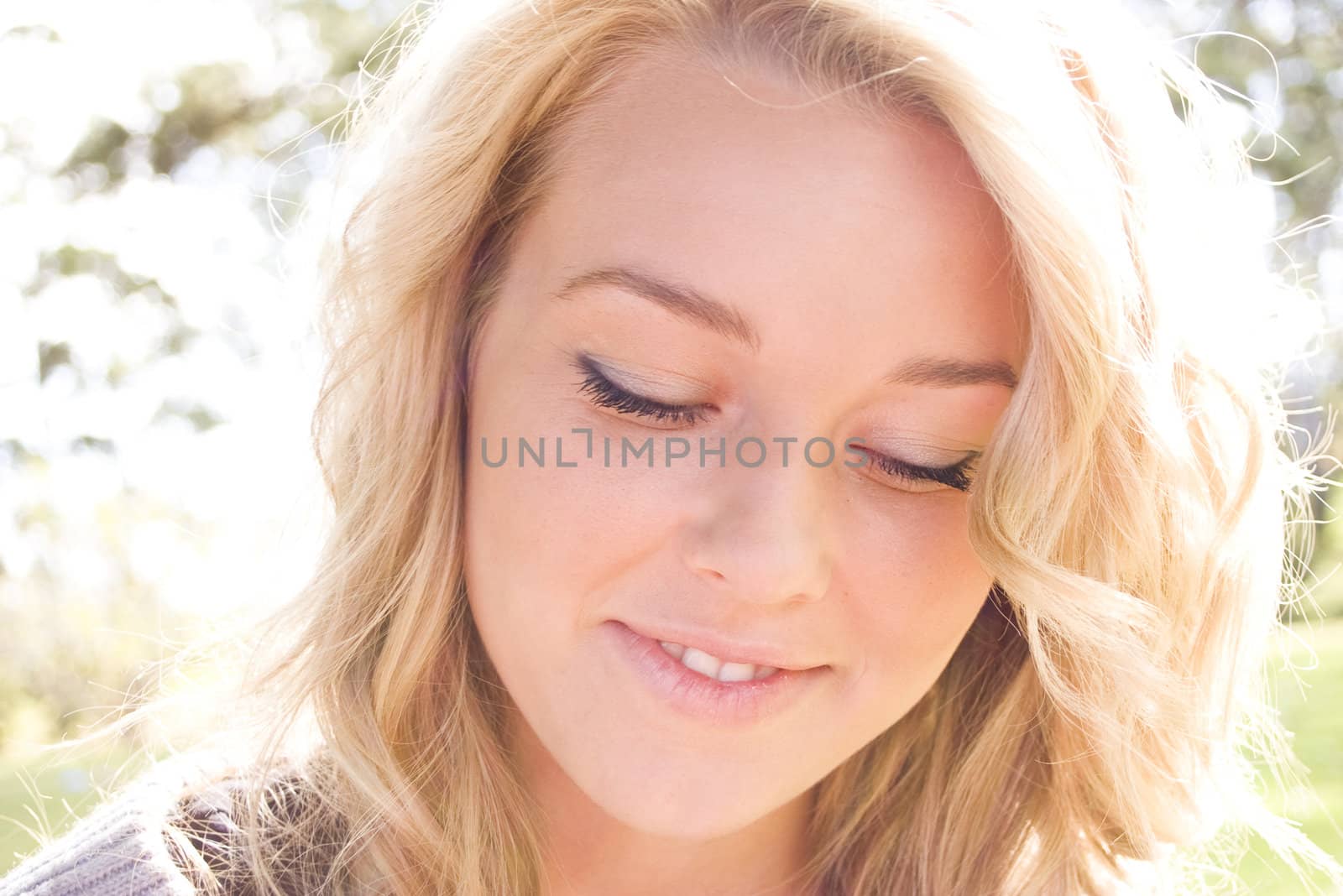 Beautiful blond girl smiling in the sunlight