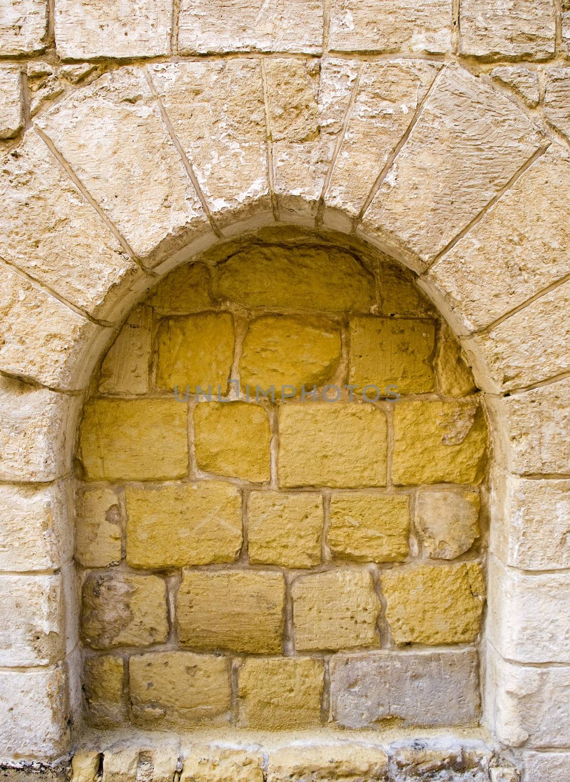 Detail and texture of a closed up Norman medieval arch in Malta