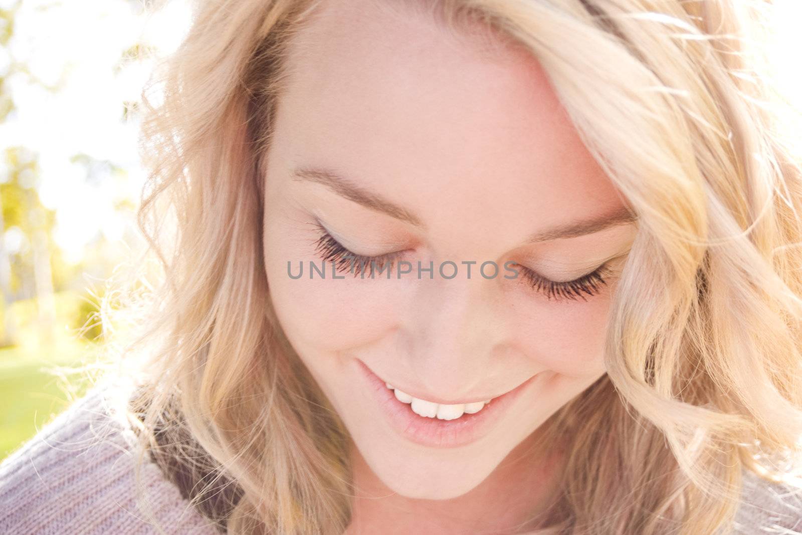 Beautiful blond girl smiling in the sunlight