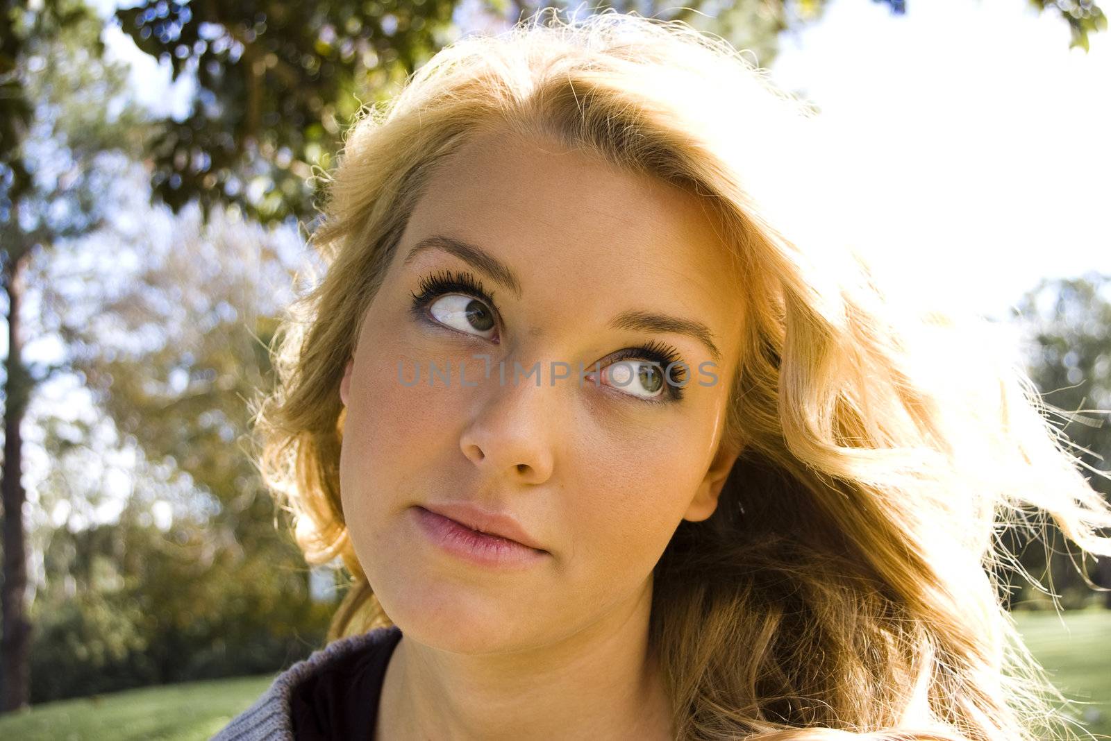 Beautiful blond girl smiling in the sunlight