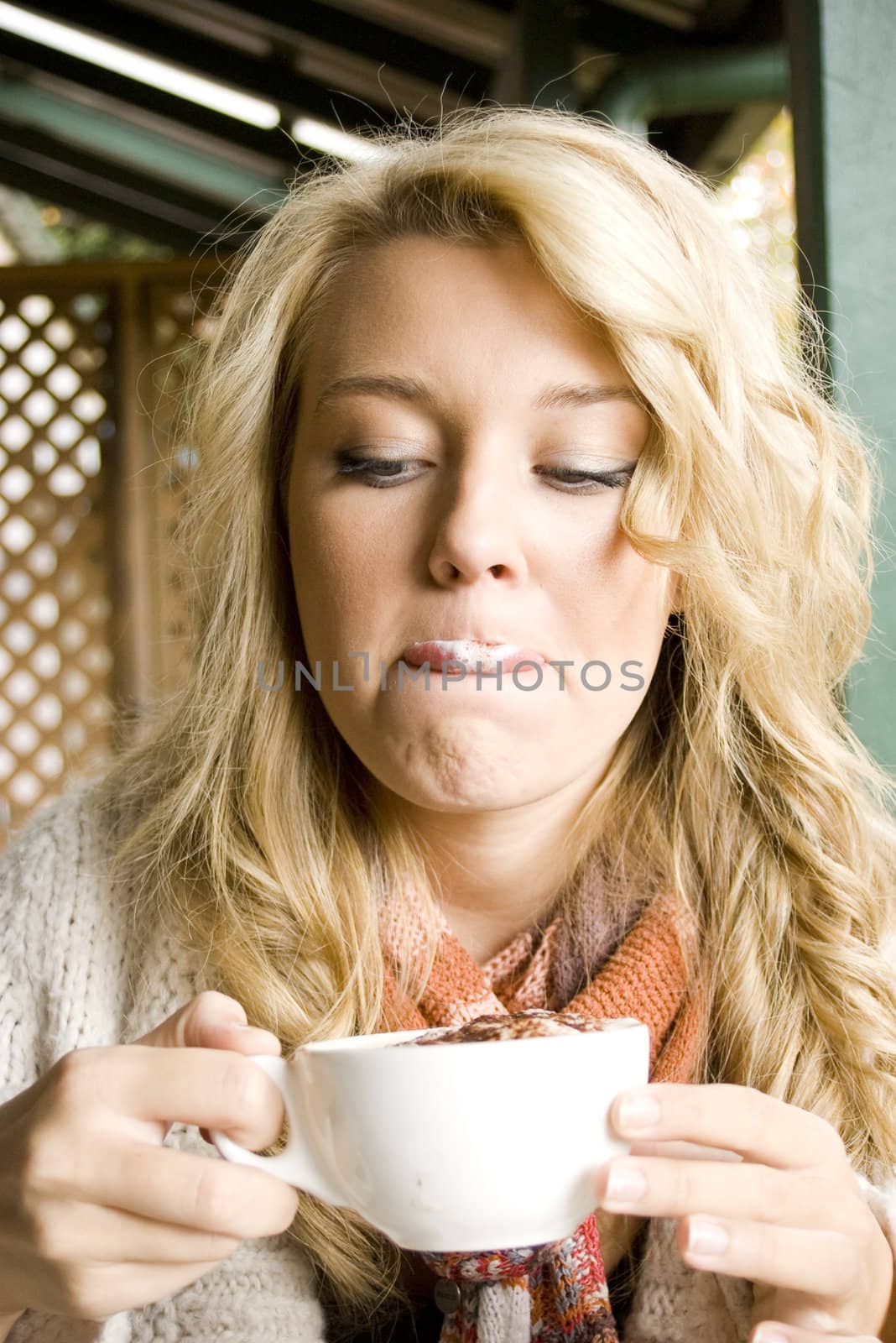 young girl at a cafe drinking coffee