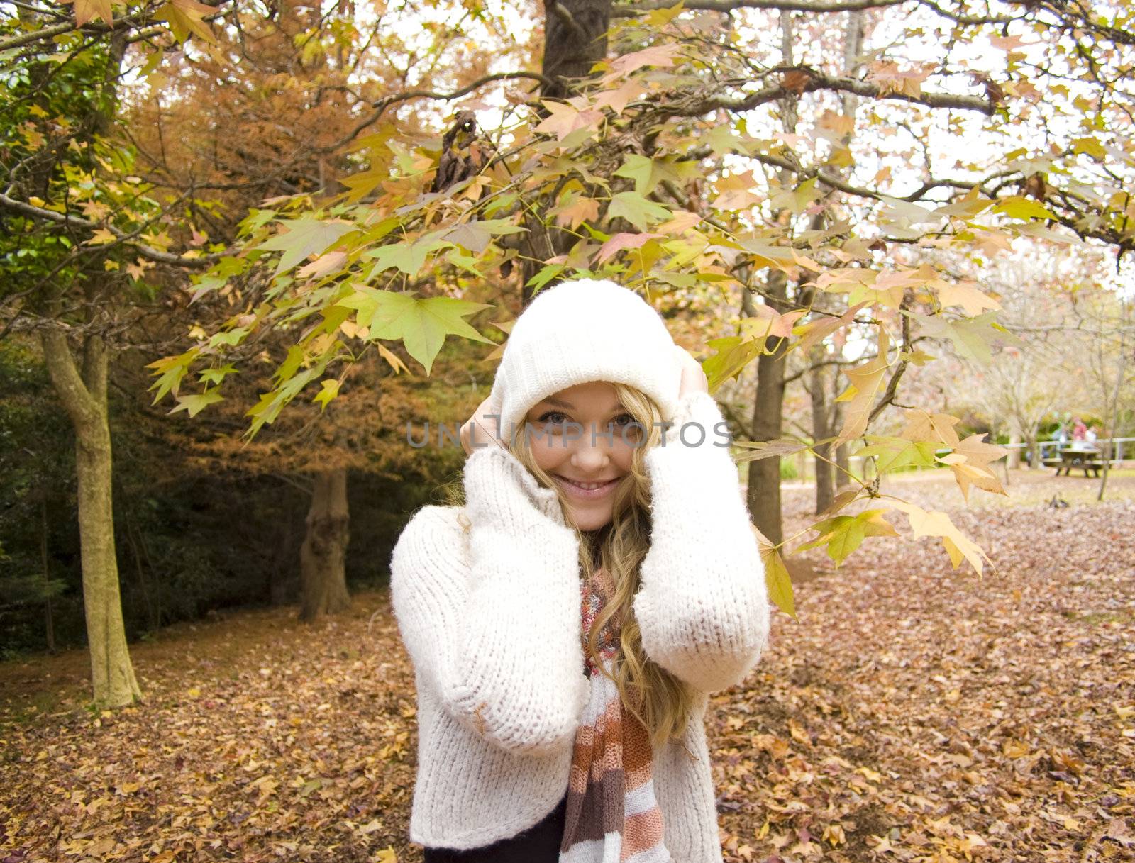 Young girl playing in the Autumn fall leaves