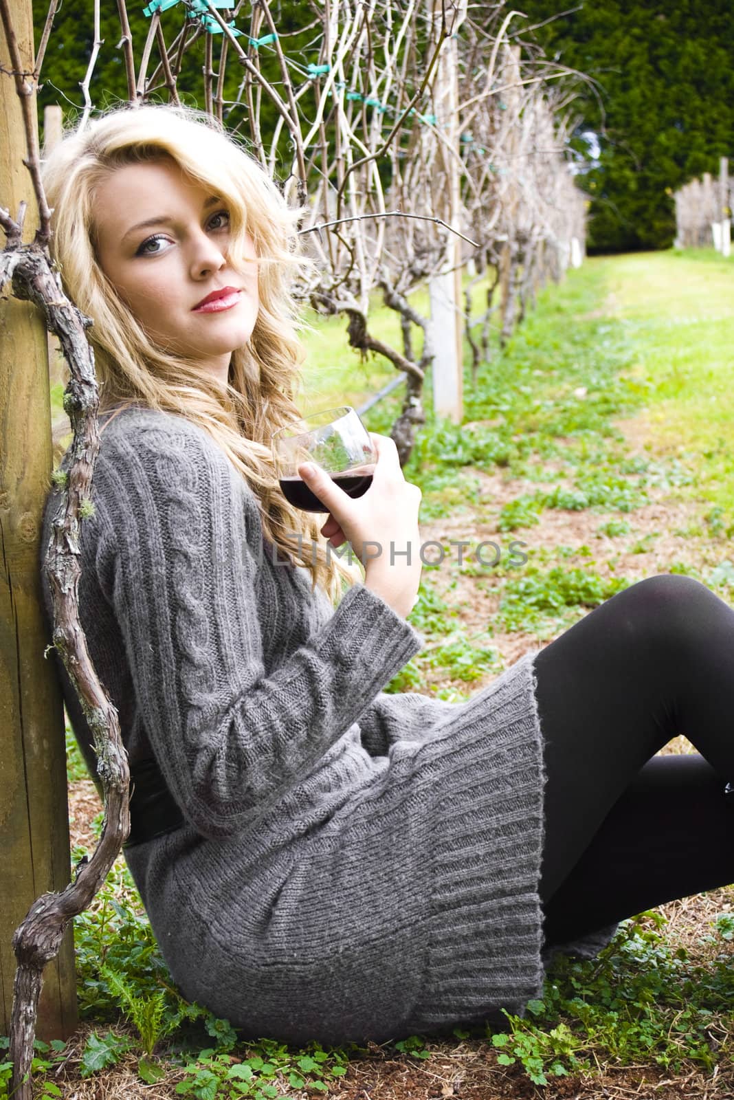 woman drinking wine at the vineyard