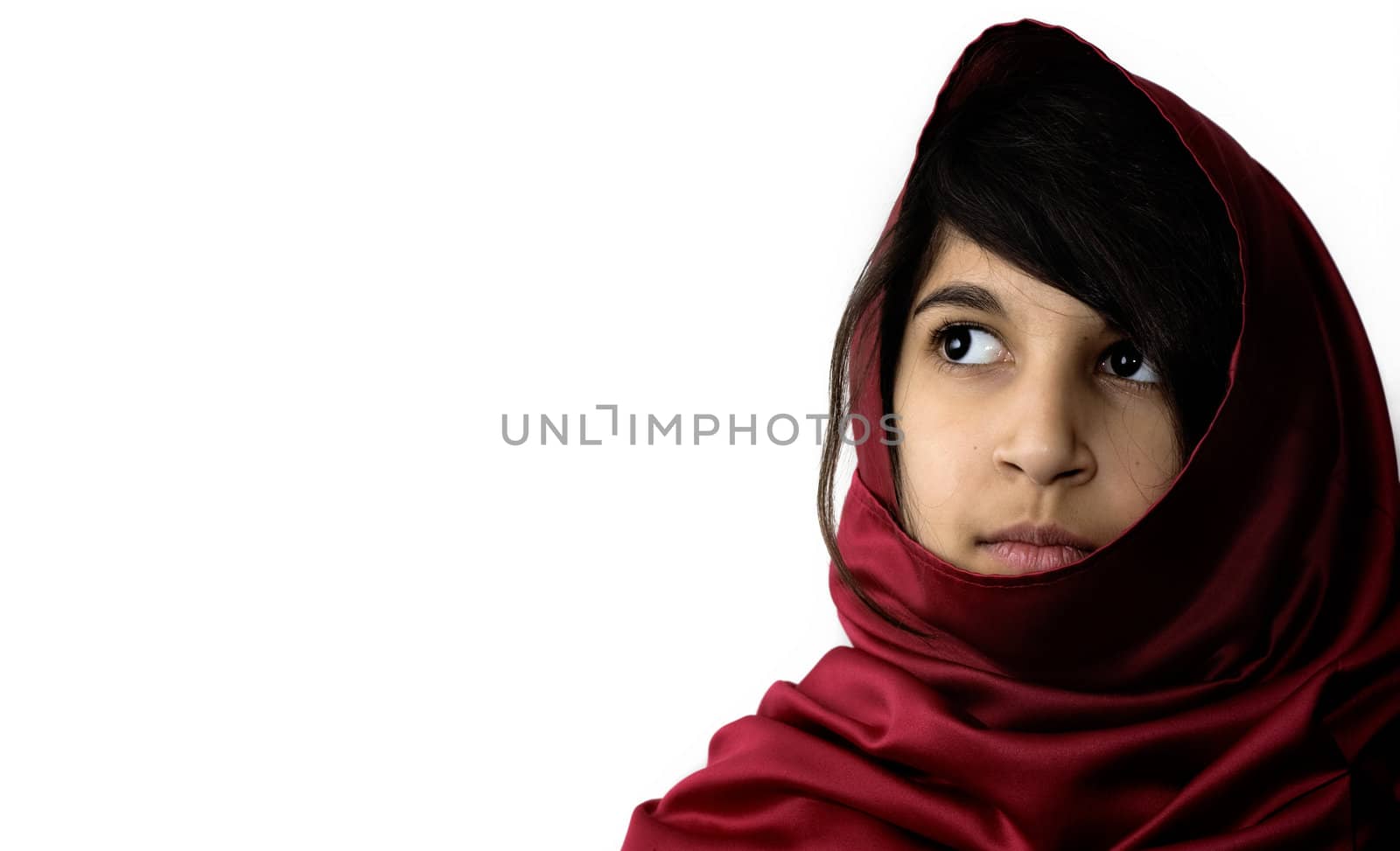 Young Indian girl looking to the side in thought.