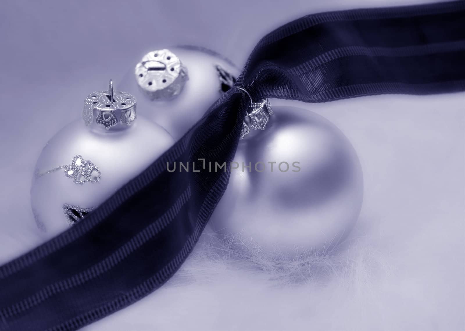 Christmas bulbs with ribbon in black and white with a cool blue tone.


