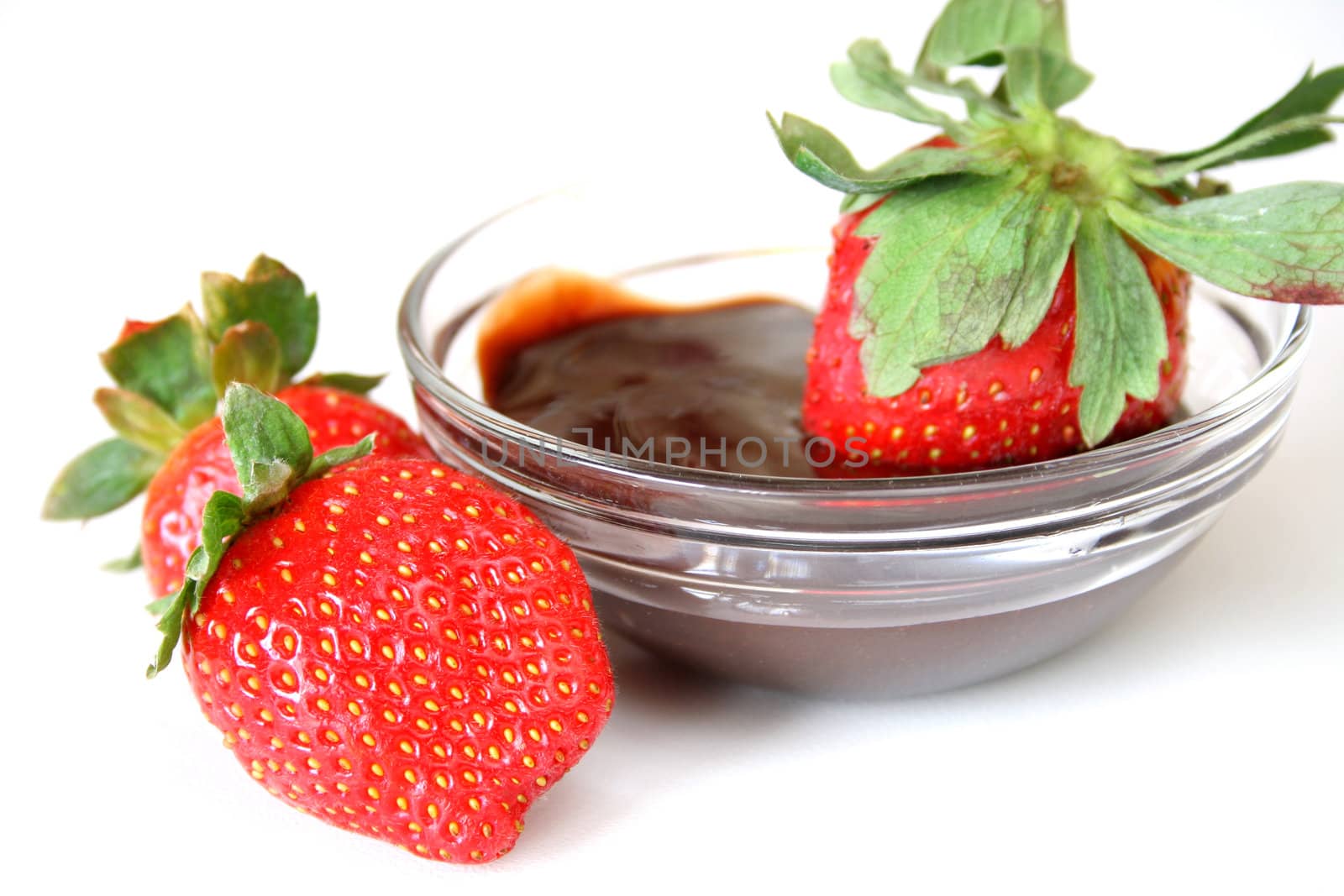 strawberries and chocolate dipping sauce isolated on a white background.
