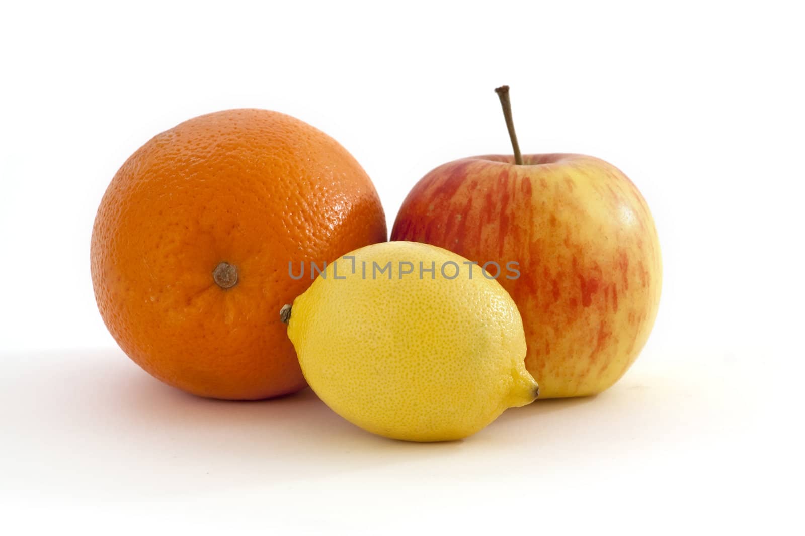 orange, lemon and apple on a white background
