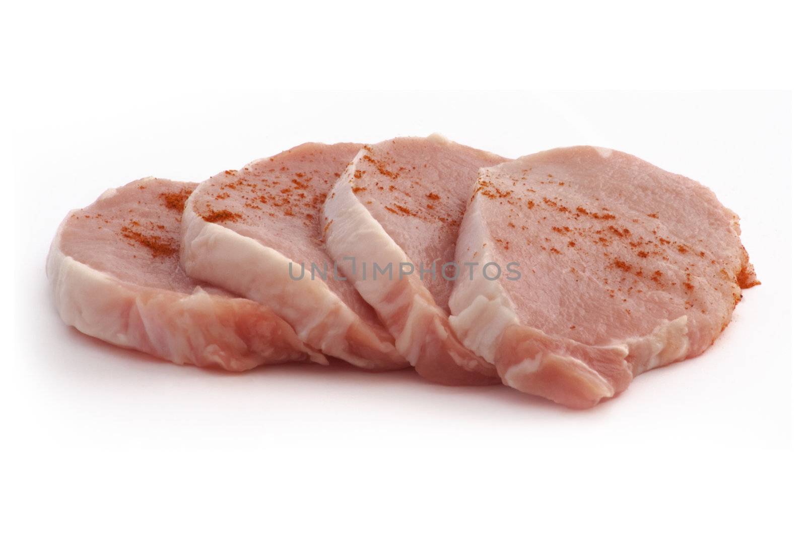 four pieces of raw pork on a white background