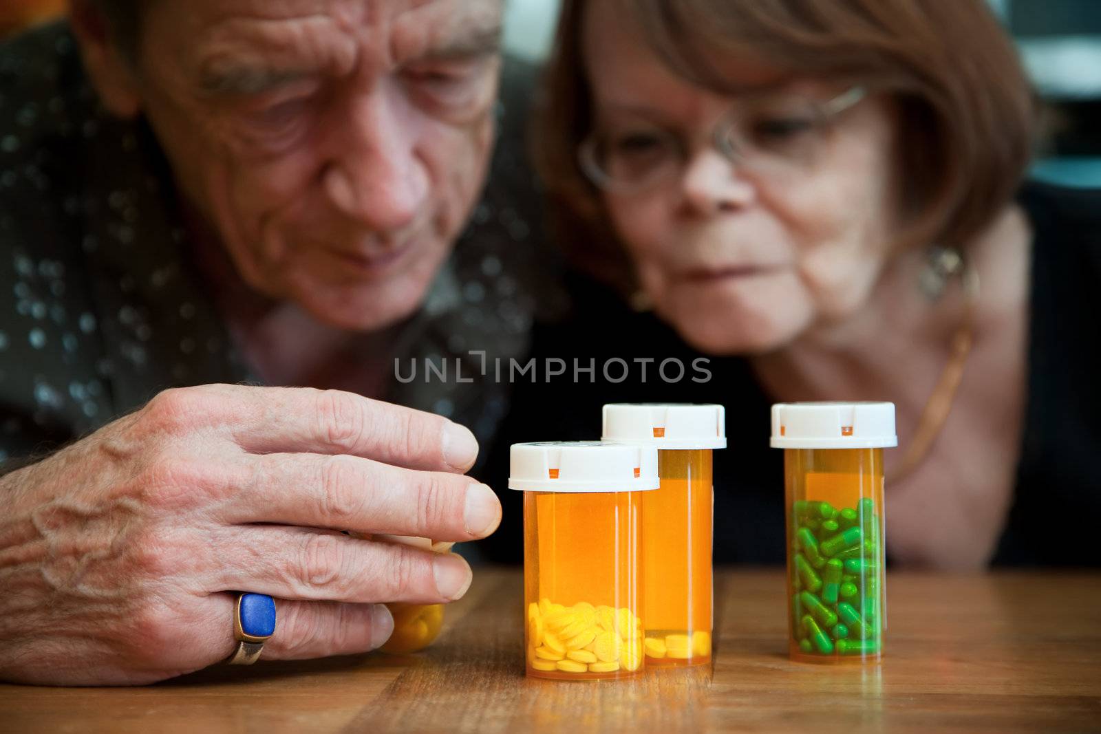 Senior couple closely examining intructions on prescription medications