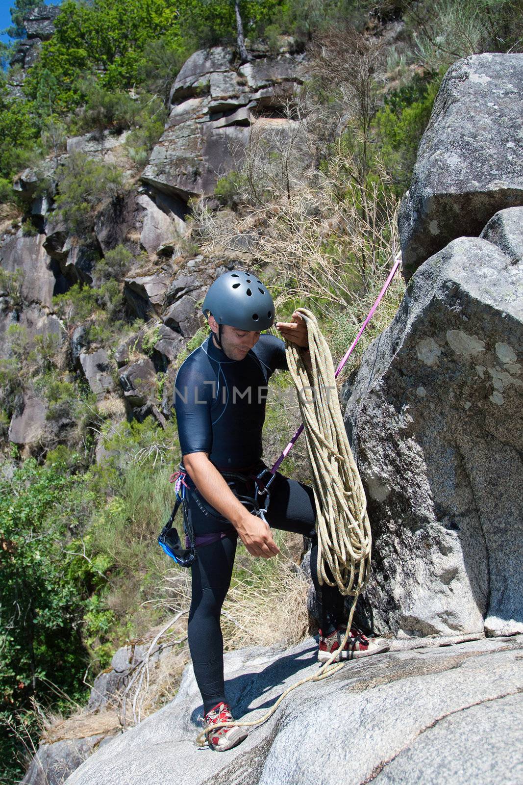 Men prepering to rappeling on waterfall