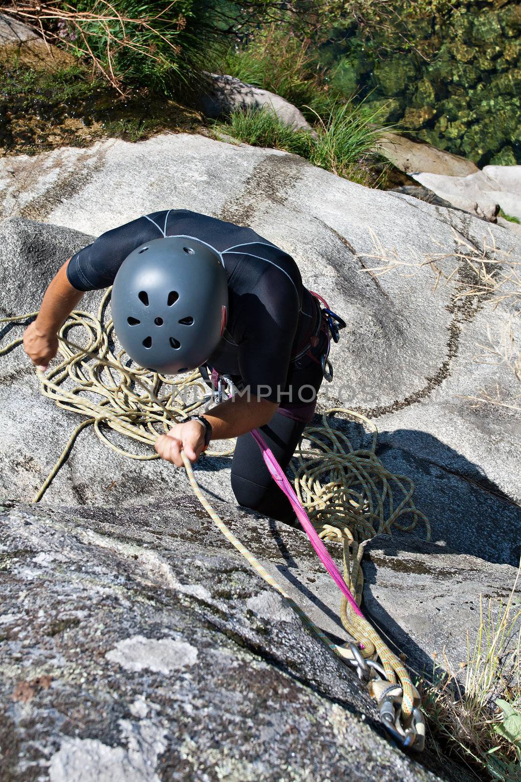 Men prepering to rappeling on waterfall